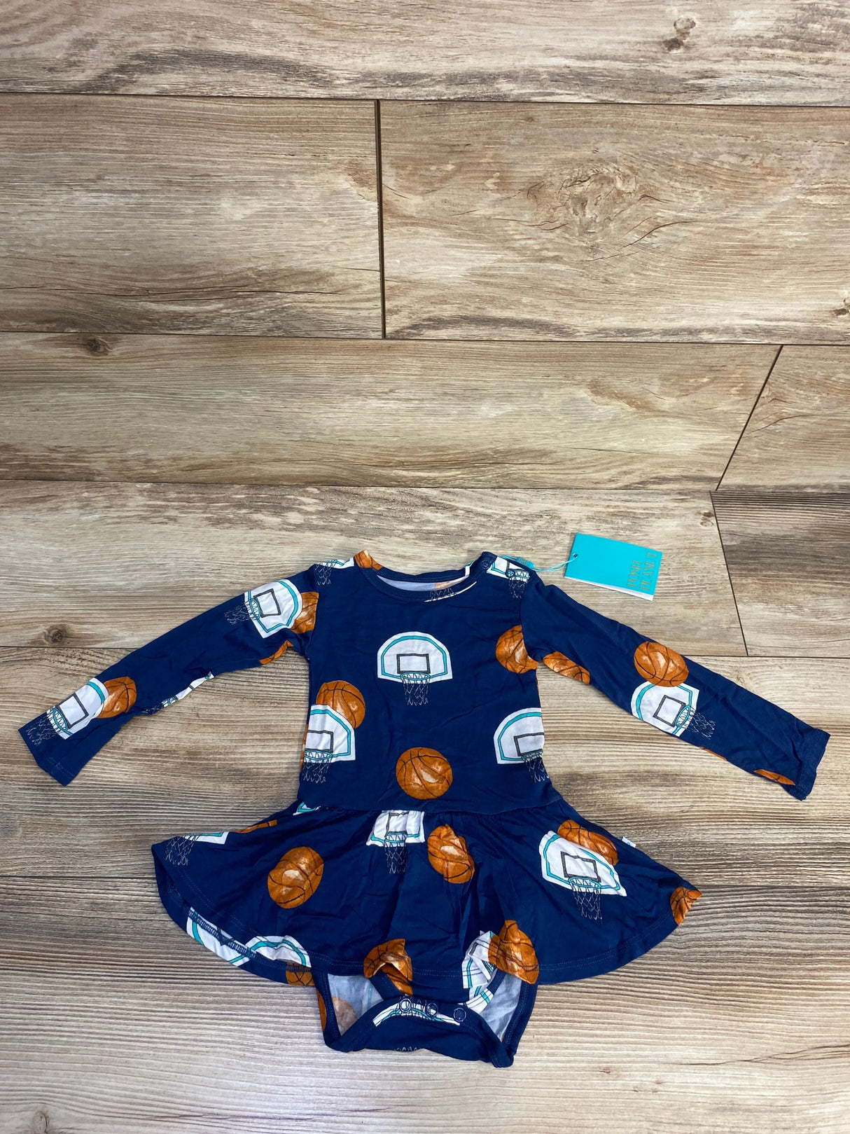 Navy blue baby dress with basketball and hoop print, long sleeves, and attached bodysuit