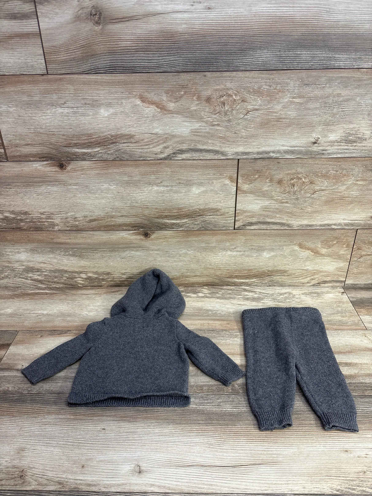 Gray knit toddler hoodie and pants set on wood background, gently used kids clothes