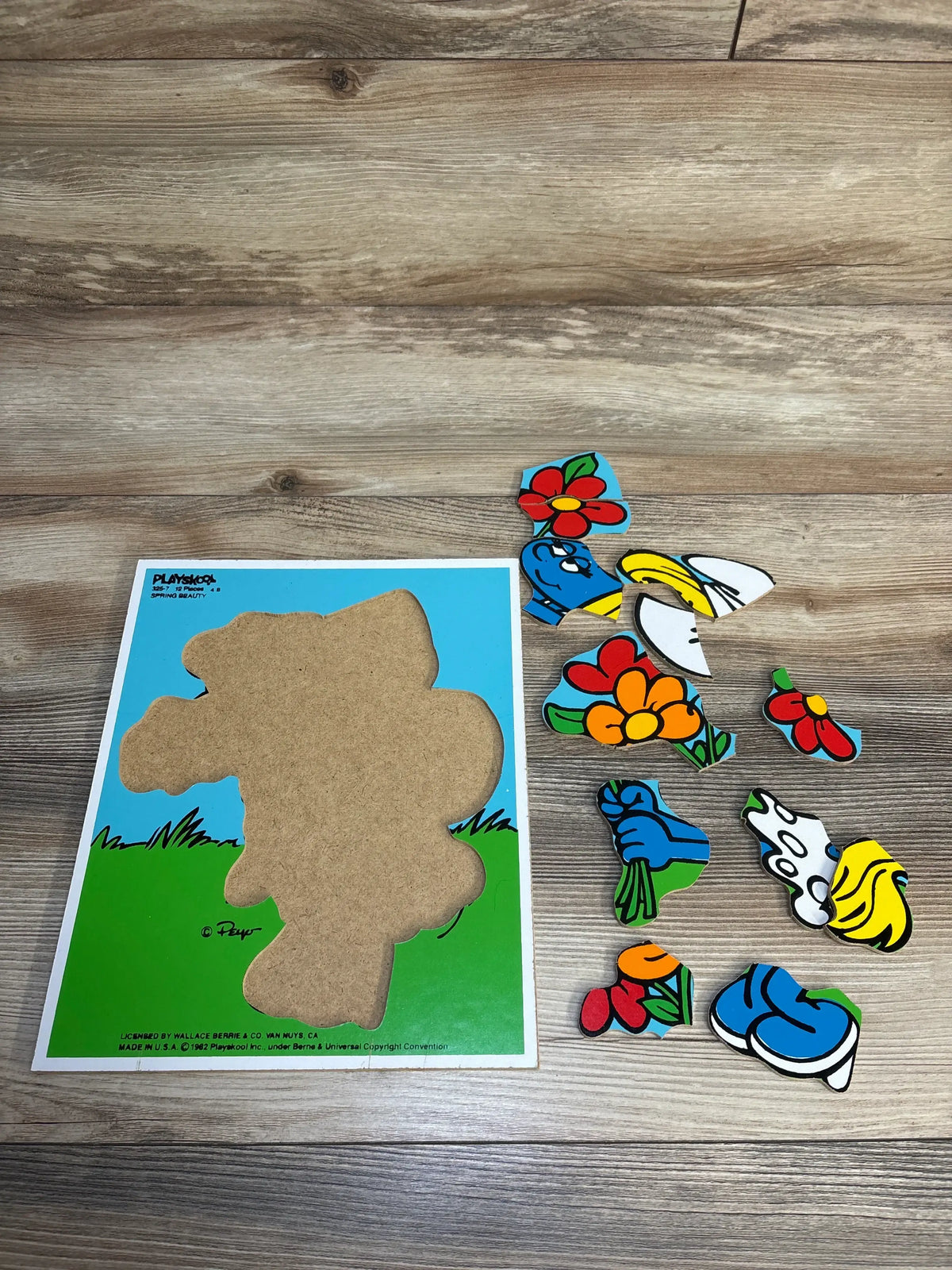 Vintage Playskool wooden puzzle with colorful cartoon pieces on wood floor