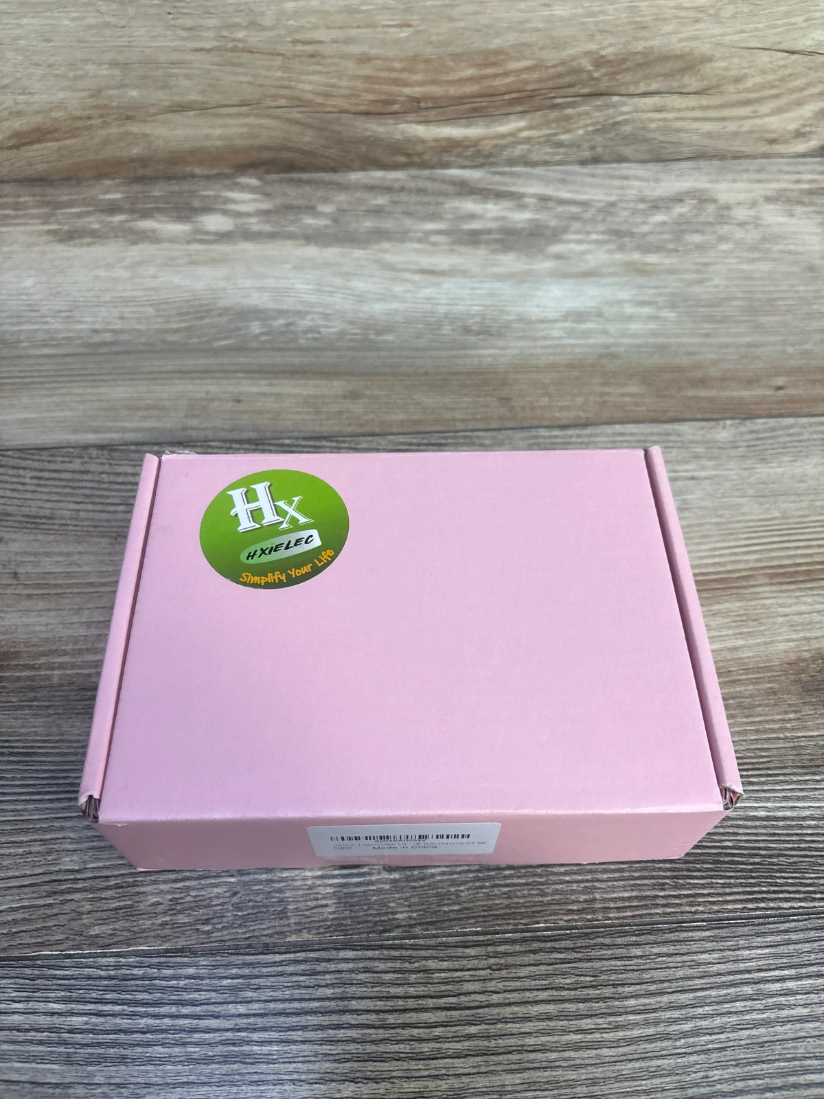 Top view of HXIELEC 3pk Clog Shoes for Doll box showcasing pink packaging on a wood-grain surface
