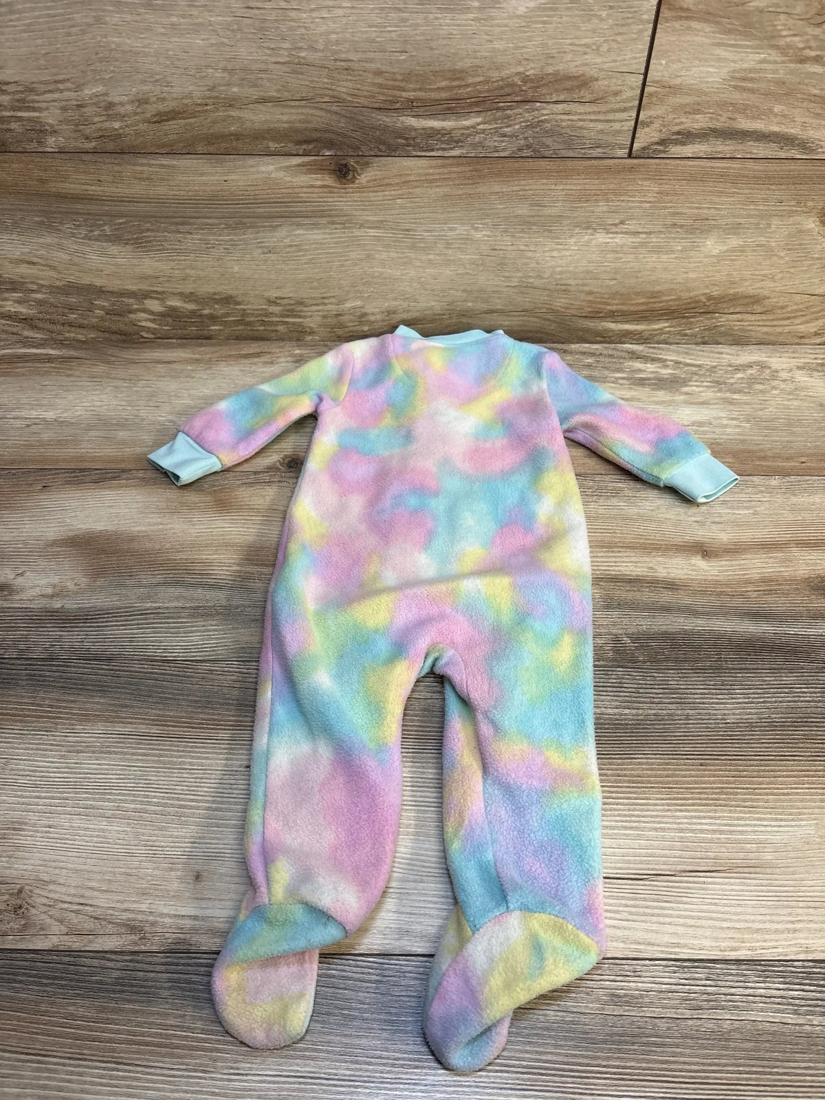 Pastel tie-dye fleece footed baby sleeper on wooden floor, long sleeves, cozy kids pajamas