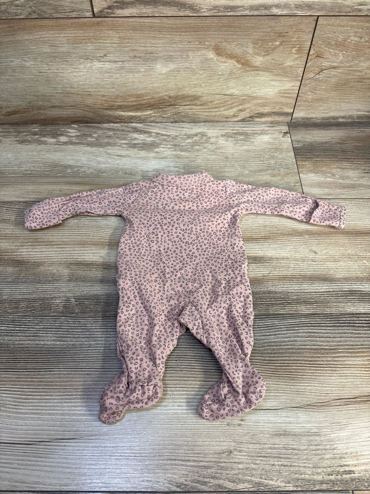 Front view of Carter’s pink kimono cat sleeper showcasing long sleeves and built-in feet with a wood-look background