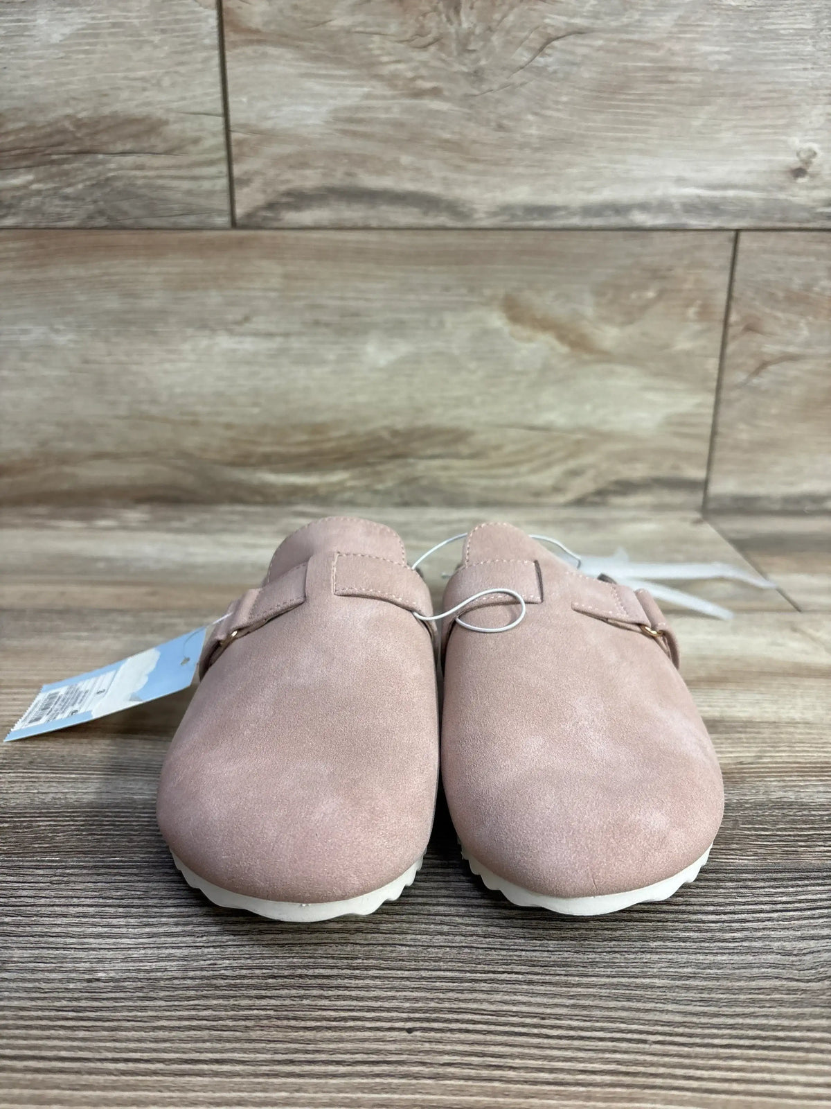 Front view of Cat and Jack Perry clogs in blush size 3Y showcasing hook and loop straps with white soles on wood surface