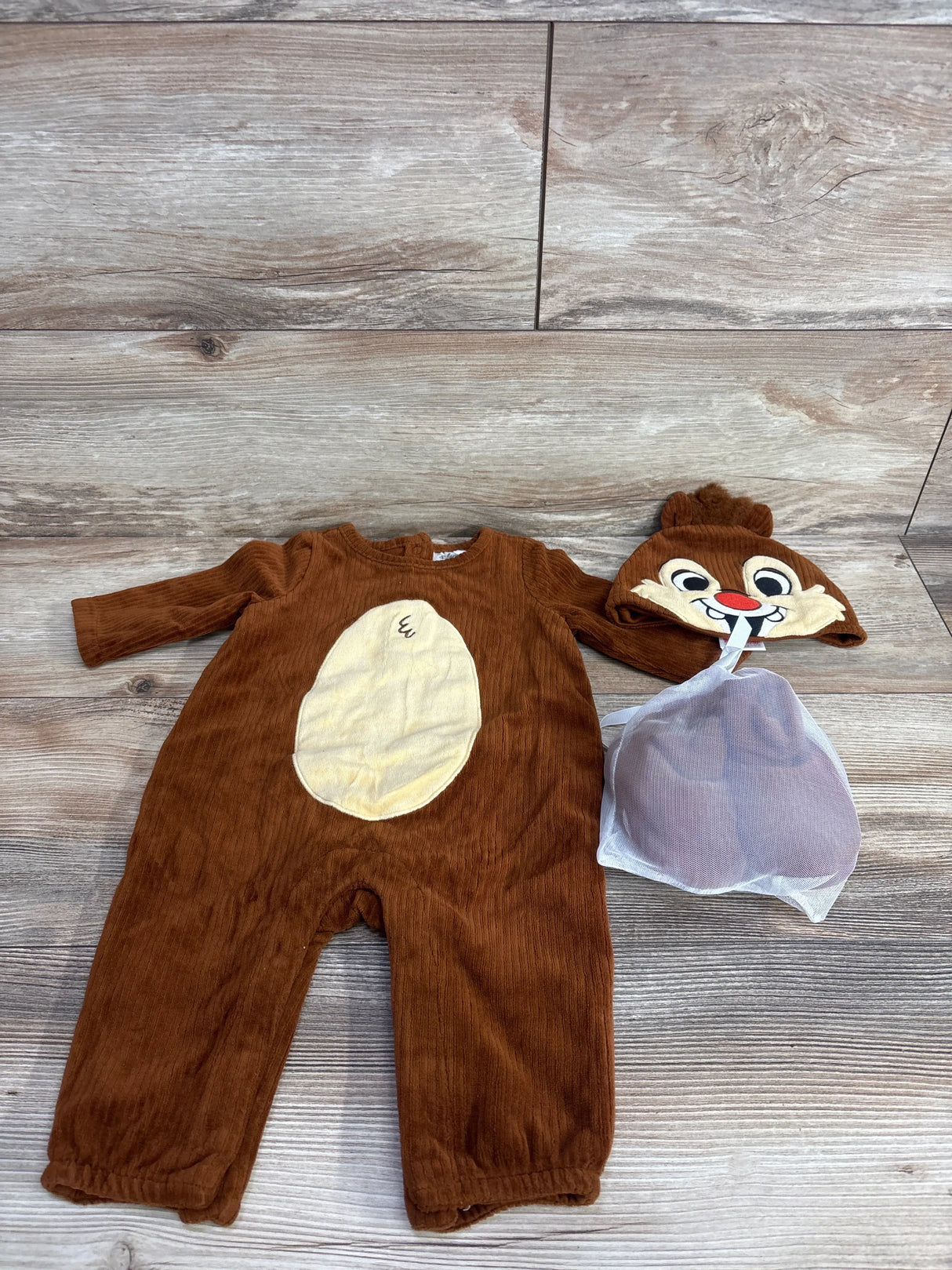 Brown baby chipmunk costume with tan belly, matching character hat, and booties on wood floor