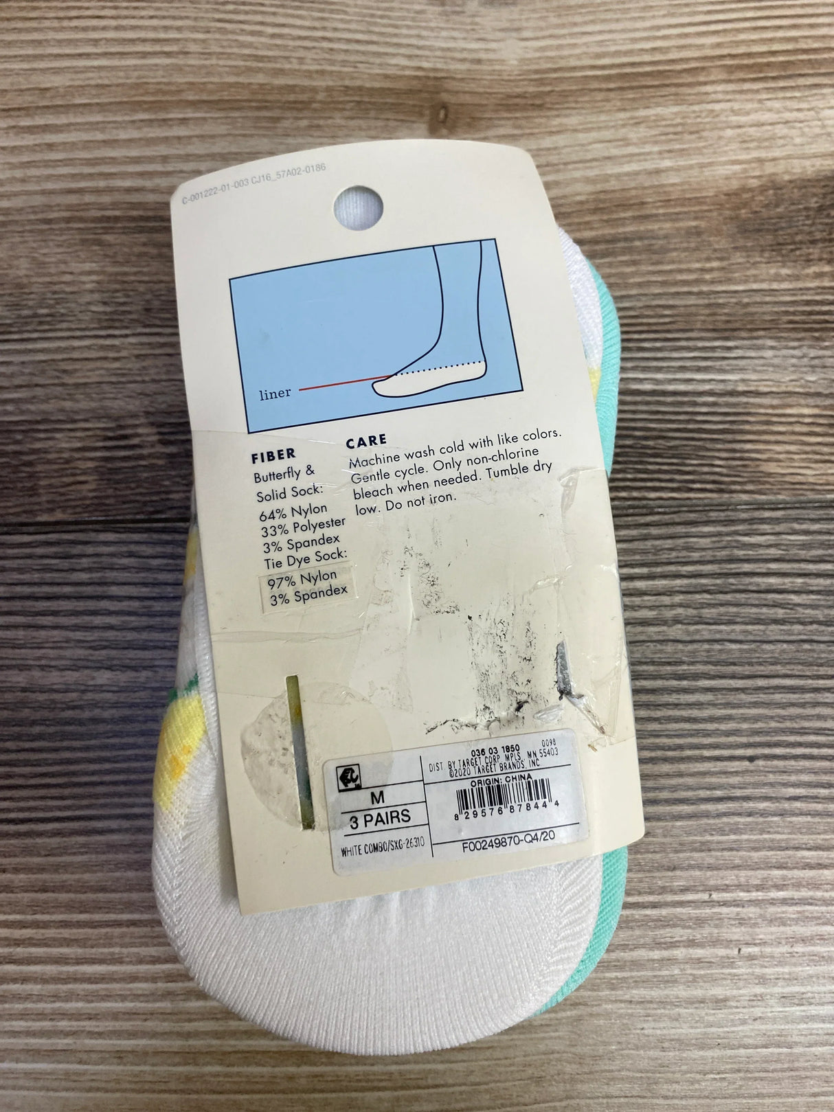 Packaging label for medium white combo no-show socks with fiber content and care instructions