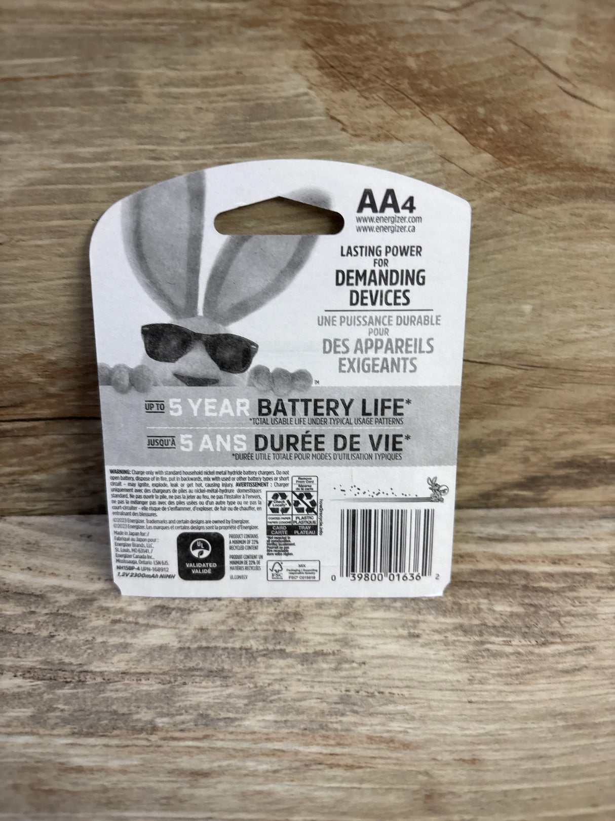 Rear view of Energizer Power Plus AA rechargeable 4-pack showing Up to 5 year battery life text and barcode on a wood surface