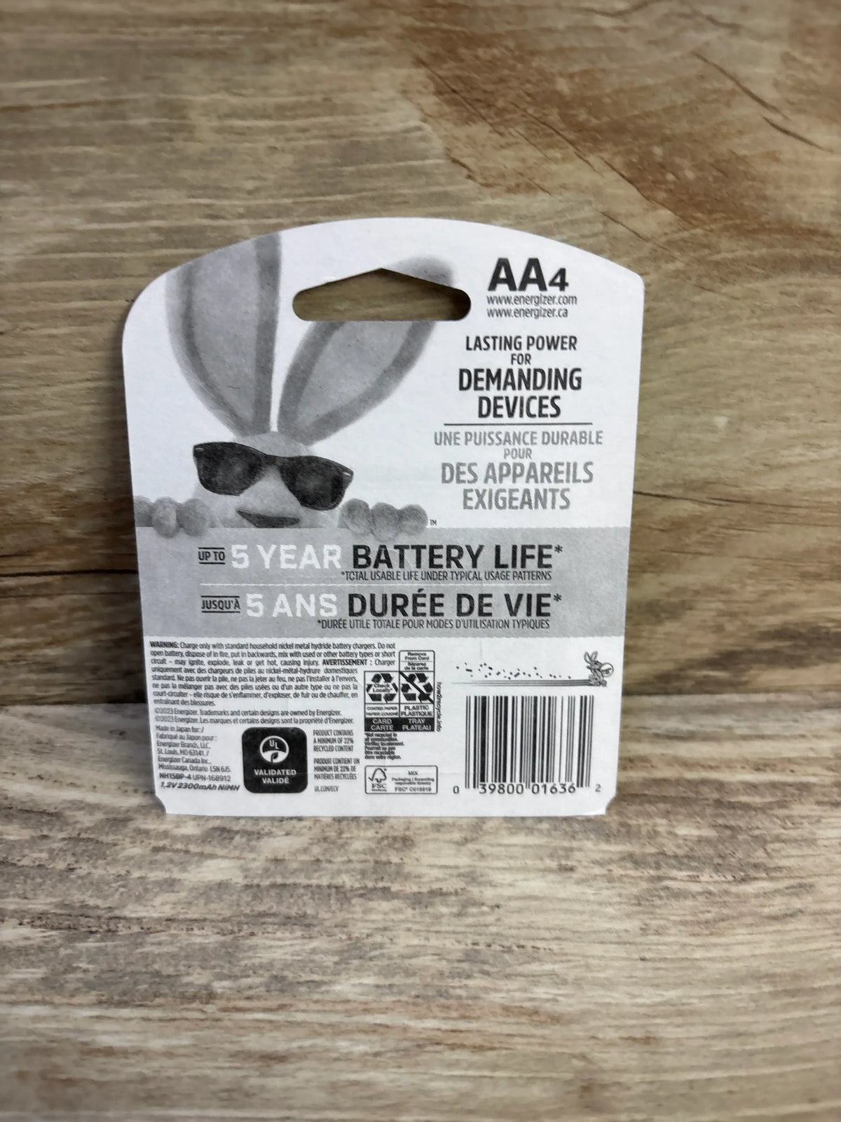 Rear view of Energizer Power Plus AA rechargeable 4-pack showing Up to 5 year battery life text and barcode on a wood surface