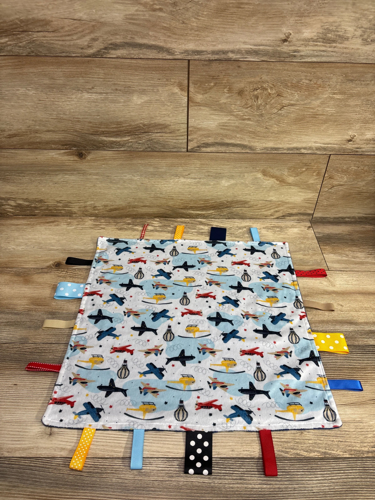 FOMAISELF minky dot baby blanket with airplane print and colorful sensory tag ribbons