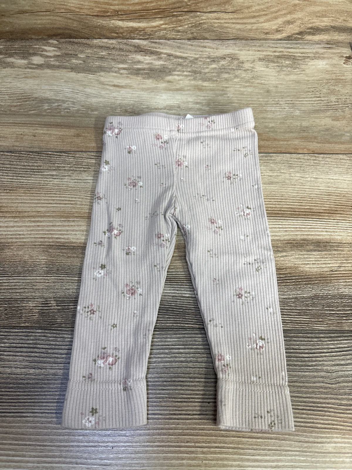 Front view of Jamie Kay lilac ribbed floral leggings in newborn size showcasing elastic waistband on wood-grain background