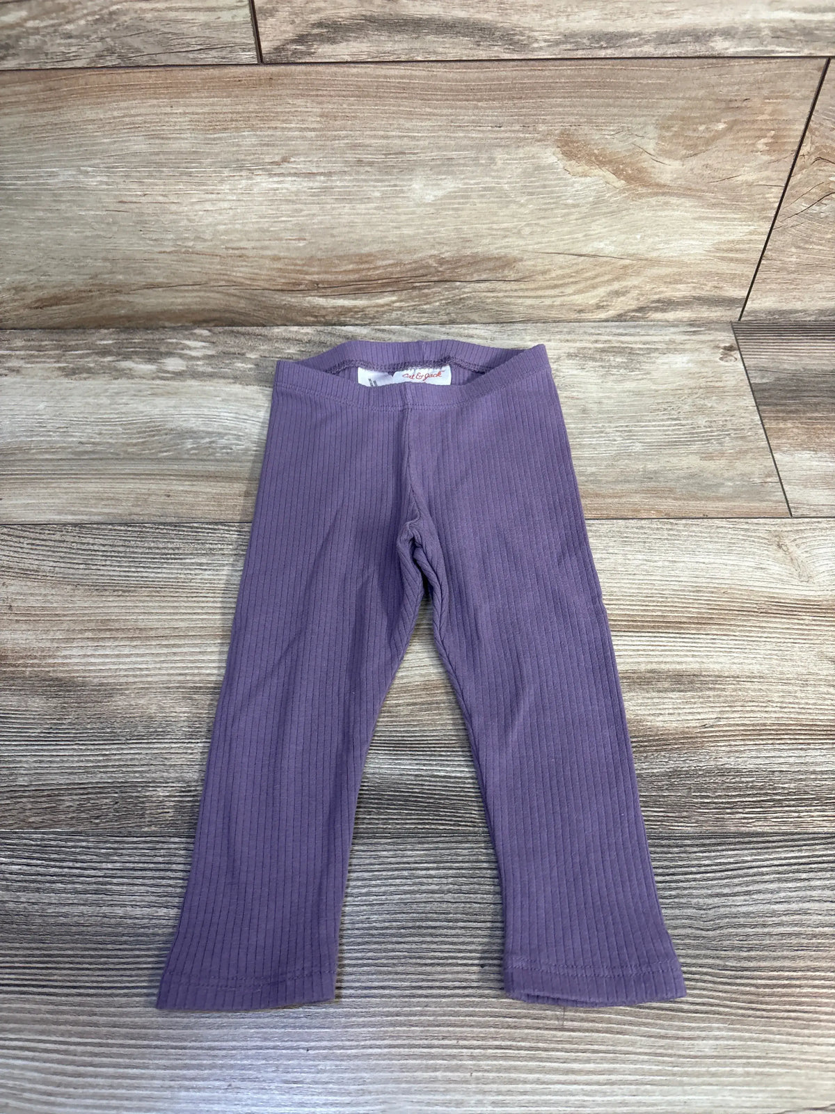 Front view of Cat & Jack purple ribbed leggings showcasing elastic waistband on a wood-look floor