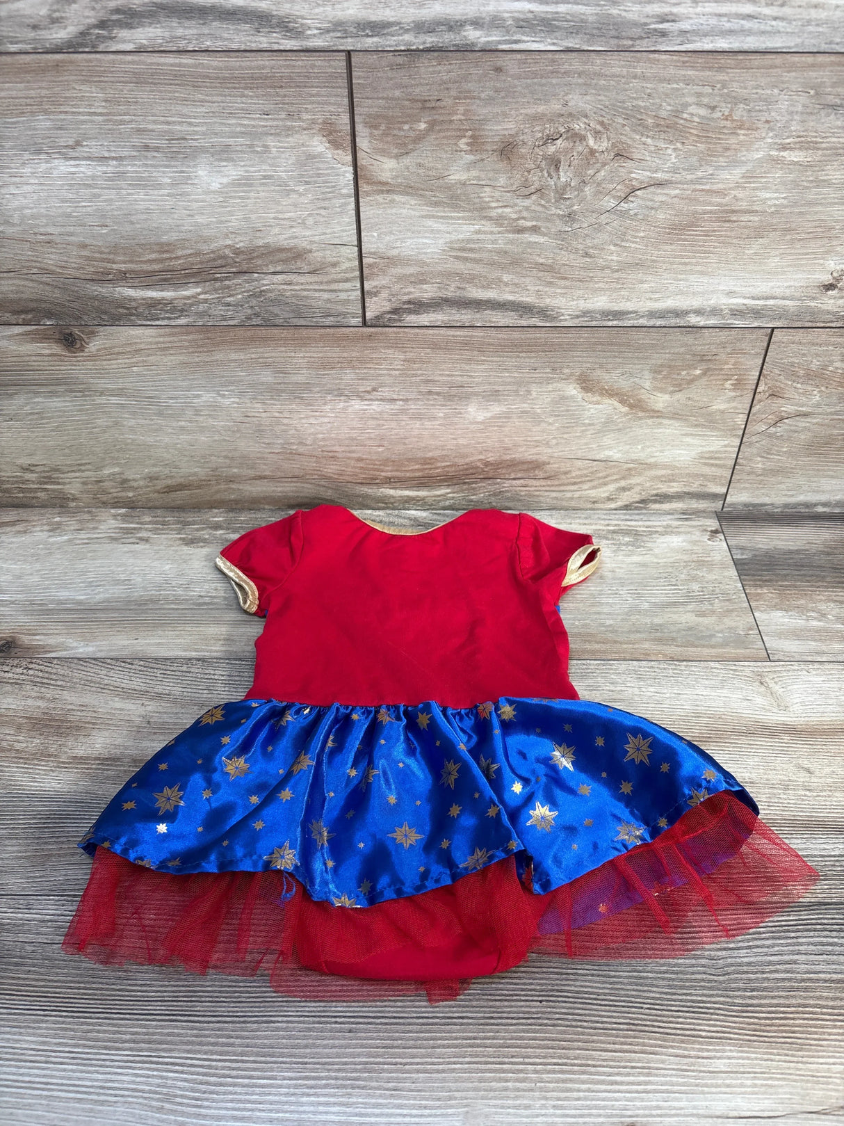 Red and blue toddler superhero dress with gold stars and tulle skirt, perfect for kids' costumes or playtime.
