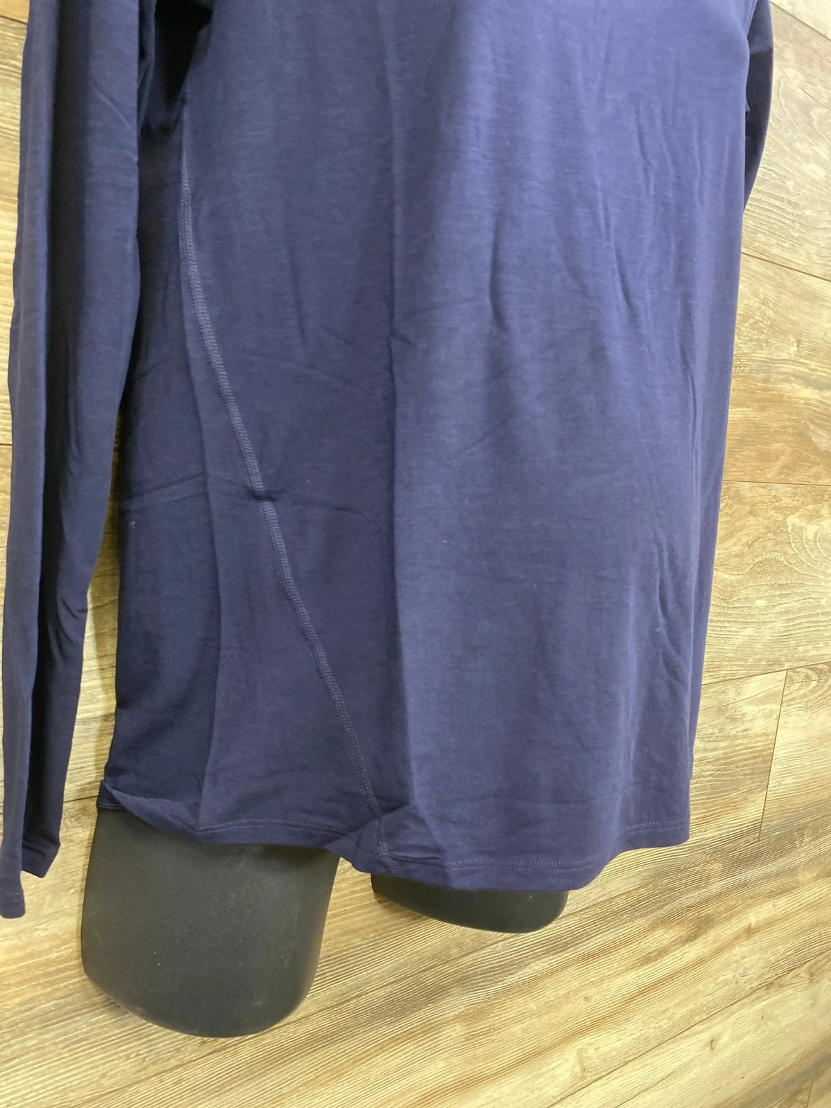 Lower-front view of navy Gap maternity long-sleeve shirt, XS, showing side seam and curved hem on black mannequin