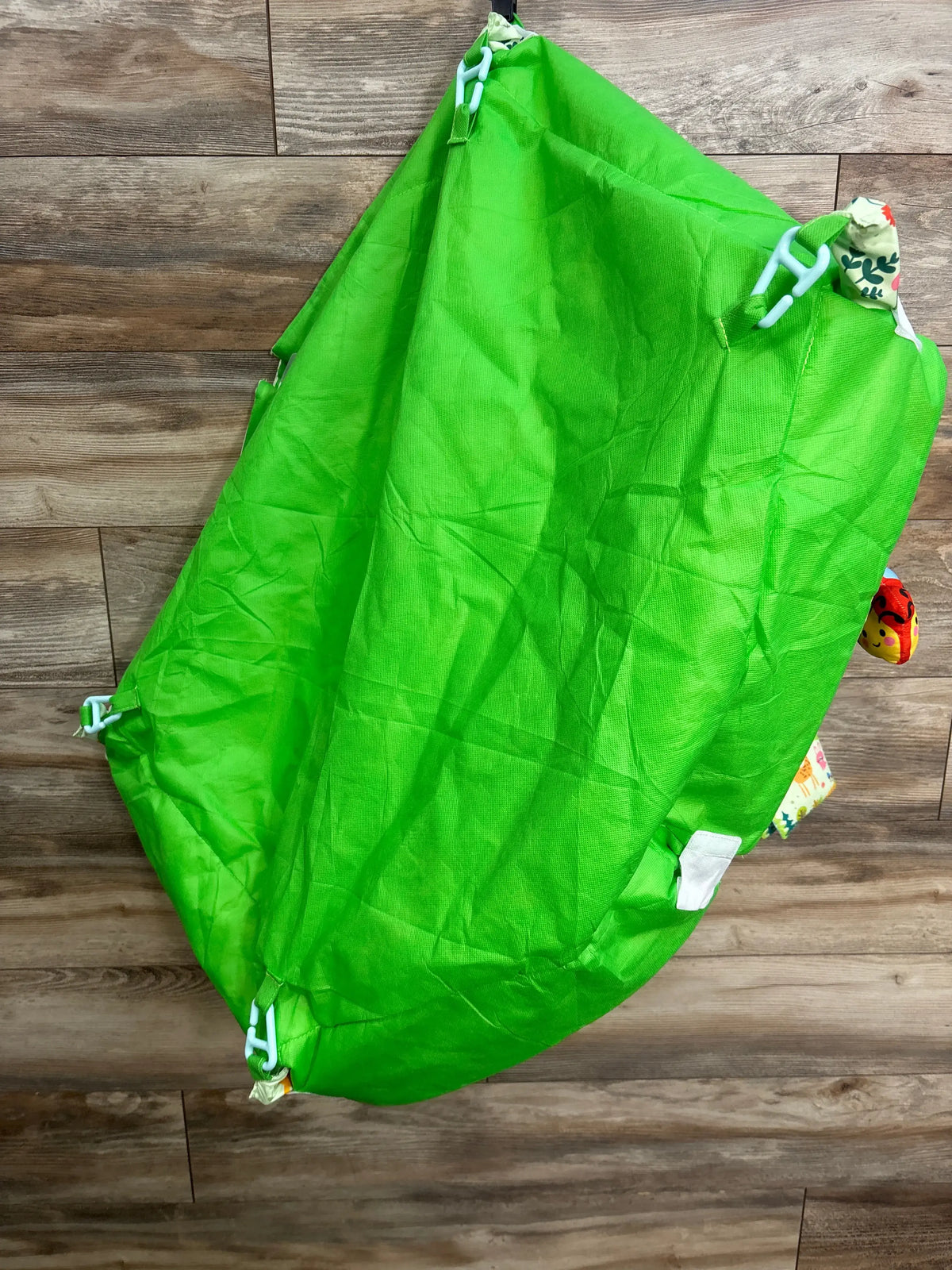 Folded green Lulunemo Animal Baby Activity Gym Playmat with white straps