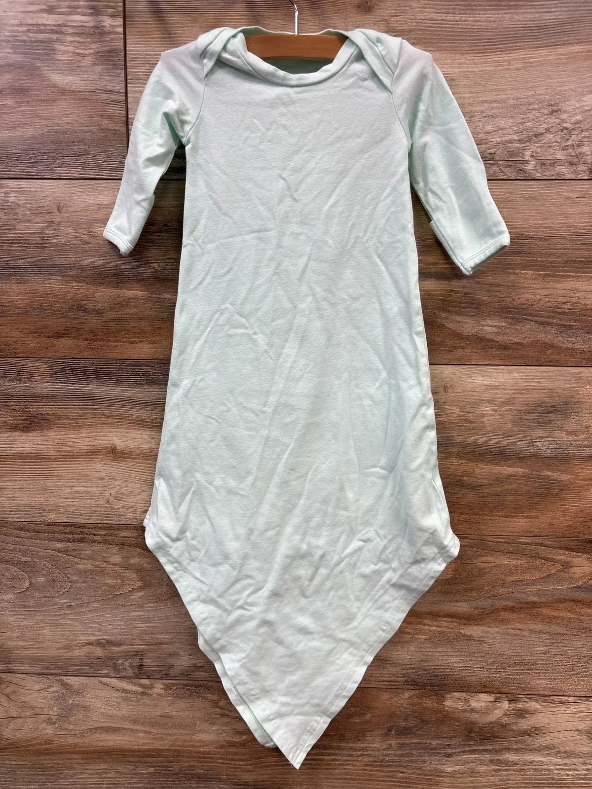 Flat lay of blue baby knotted gown size 3 months showcasing long sleeves and knotted pointed hem on wood background
