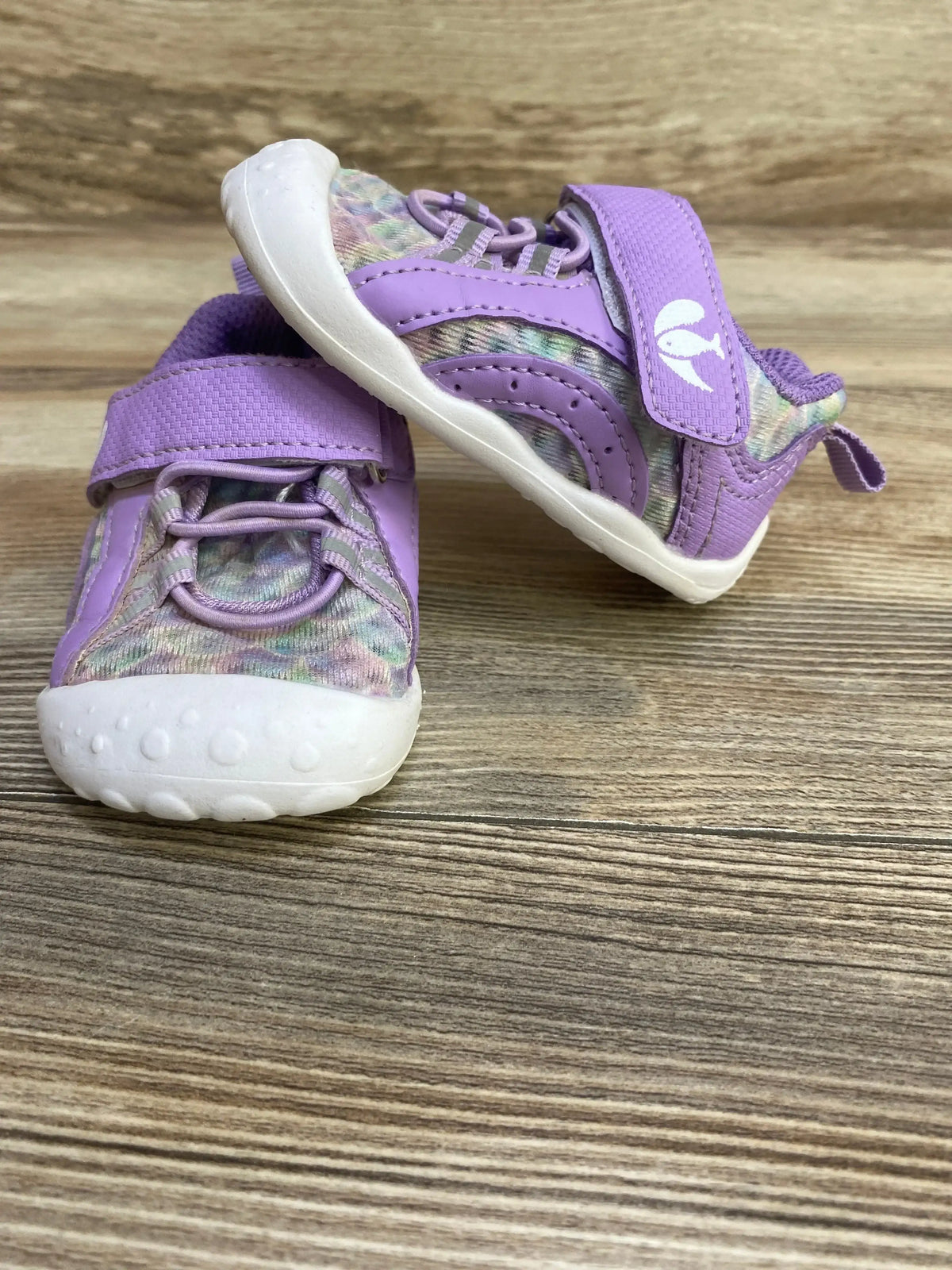Front and side view of purple barefoot water shoes size 4/5C showing velcro strap, patterned knit upper and white sole on wood