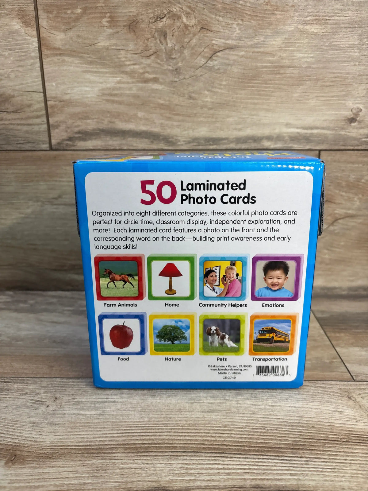 Back view of Lakeshore Infant/Toddler Photo Library showcasing 50 laminated photo cards in eight categories with wood background