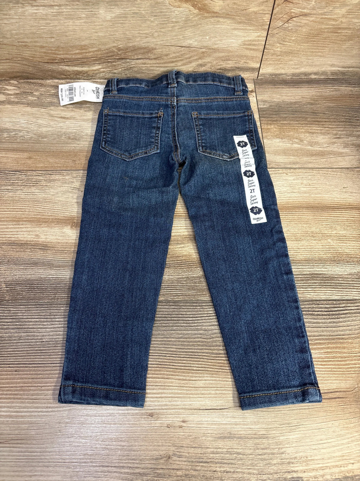 Toddler dark wash denim jeans size 2T with tags on wooden surface