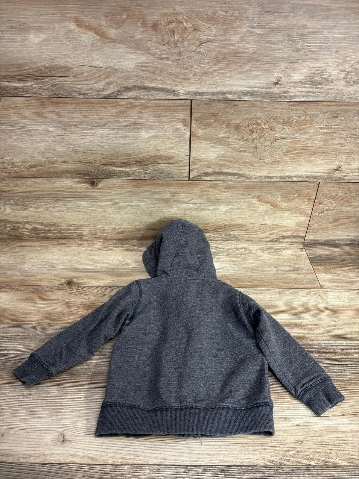 Back view of Cat & Jack full-zip toddler jacket (gray, 2T) showcasing hood, ribbed cuffs and hem, laid flat on wood floor