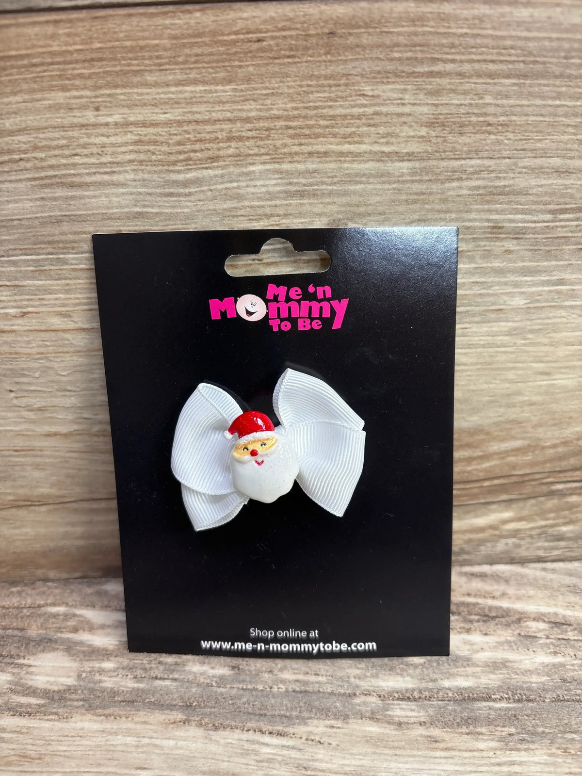 White ribbon bow with Santa Claus charm, kids holiday hair accessory on black card