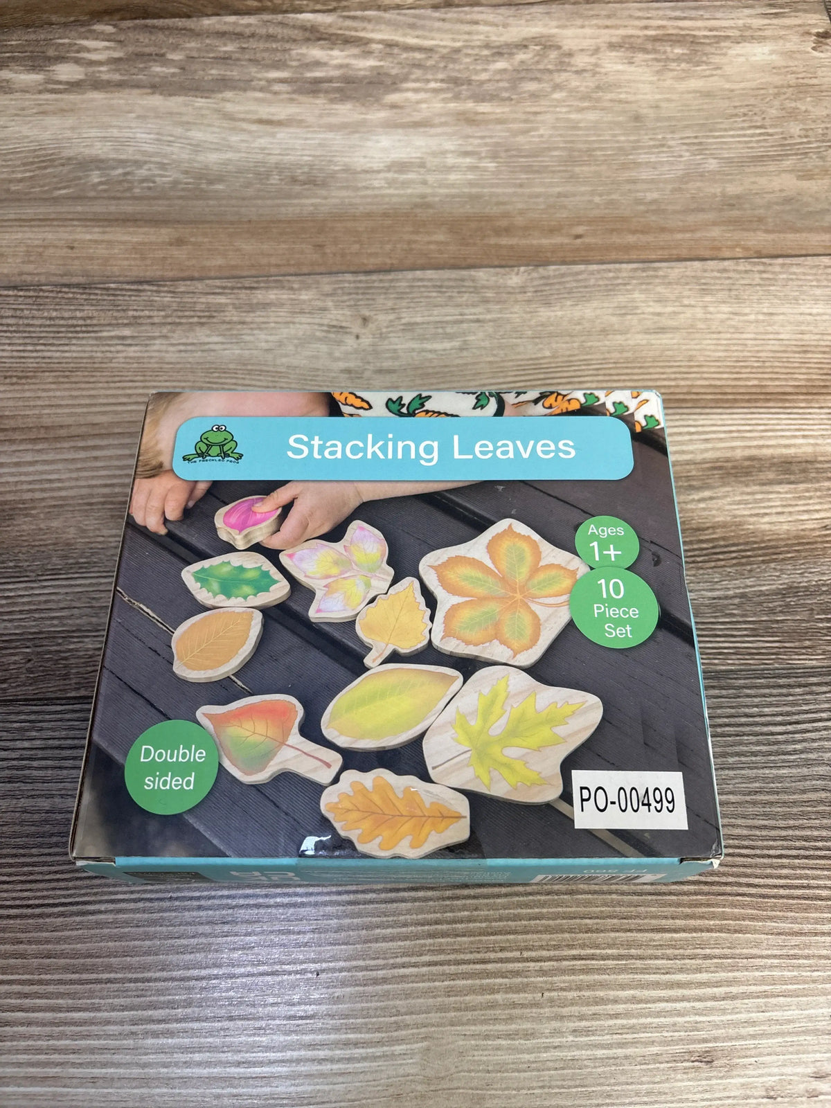 Front view of The Freckled Frog Stacking Leaves wooden block set showing 10 leaf shaped blocks and double sided illustrations