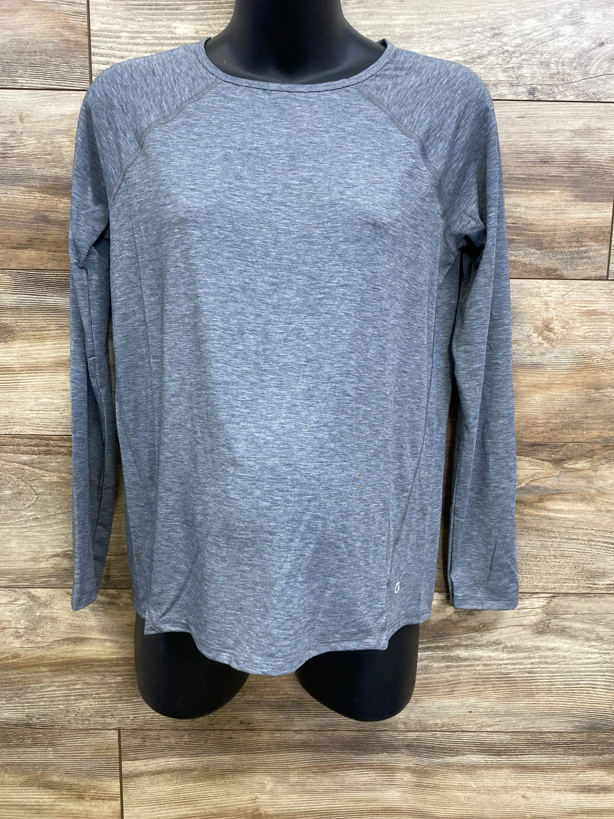 Front view of Gap maternity long-sleeve grey shirt on mannequin showing crew neck and raglan sleeves against wood background