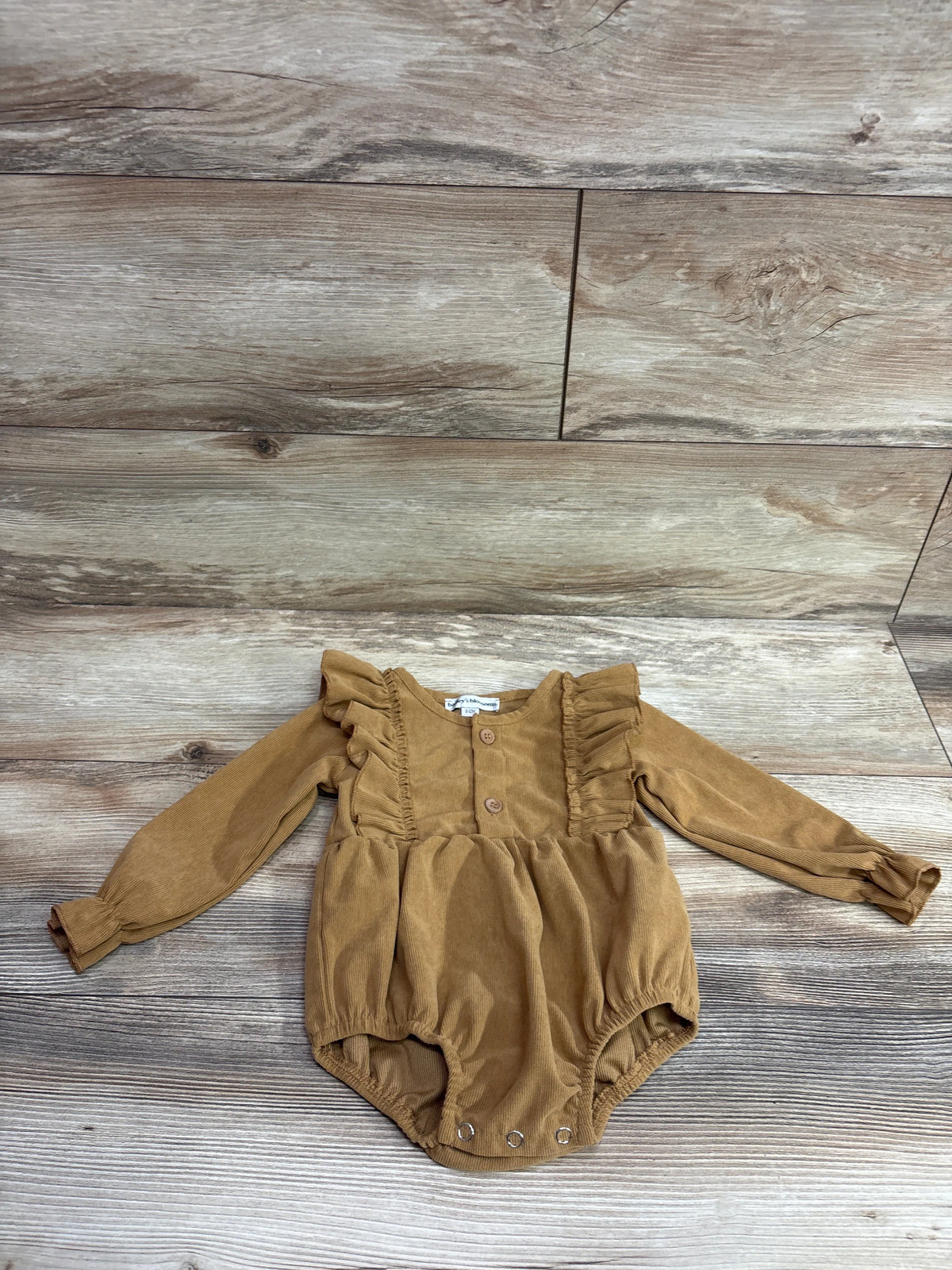 Front view of Bailey’s Blossoms Samantha bubble romper in Haystack with ruffled shoulders, long sleeves, and snaps