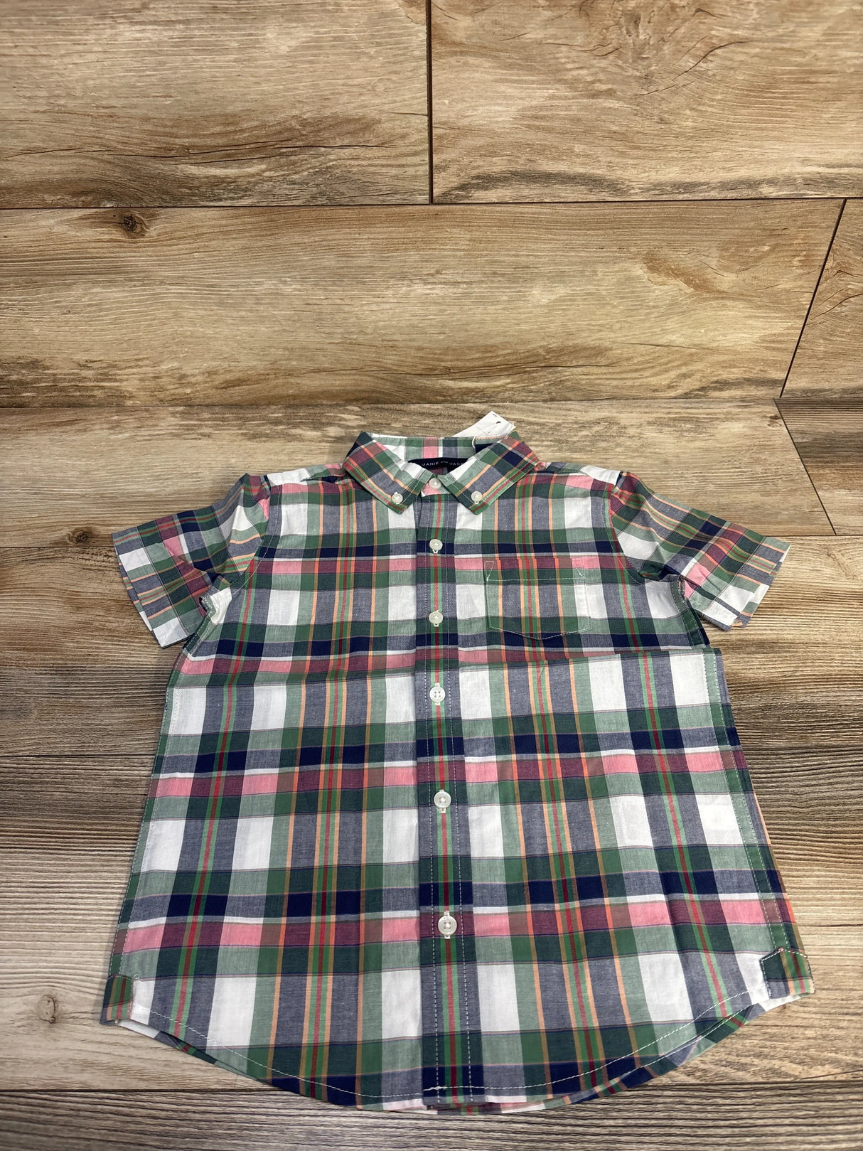 Front flat-lay of Madras plaid short-sleeve button-down shirt size 5T showcasing multicolor plaid on wood background