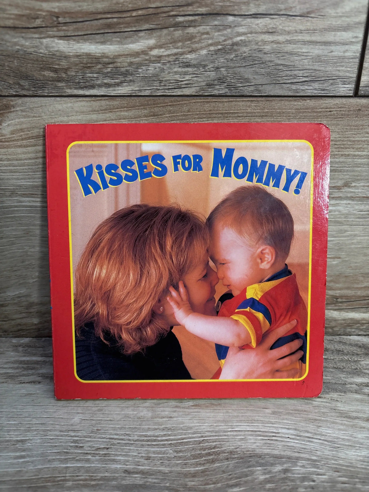Book cover titled 'Kisses for Mommy!' showing a mother and baby touching noses and smiling