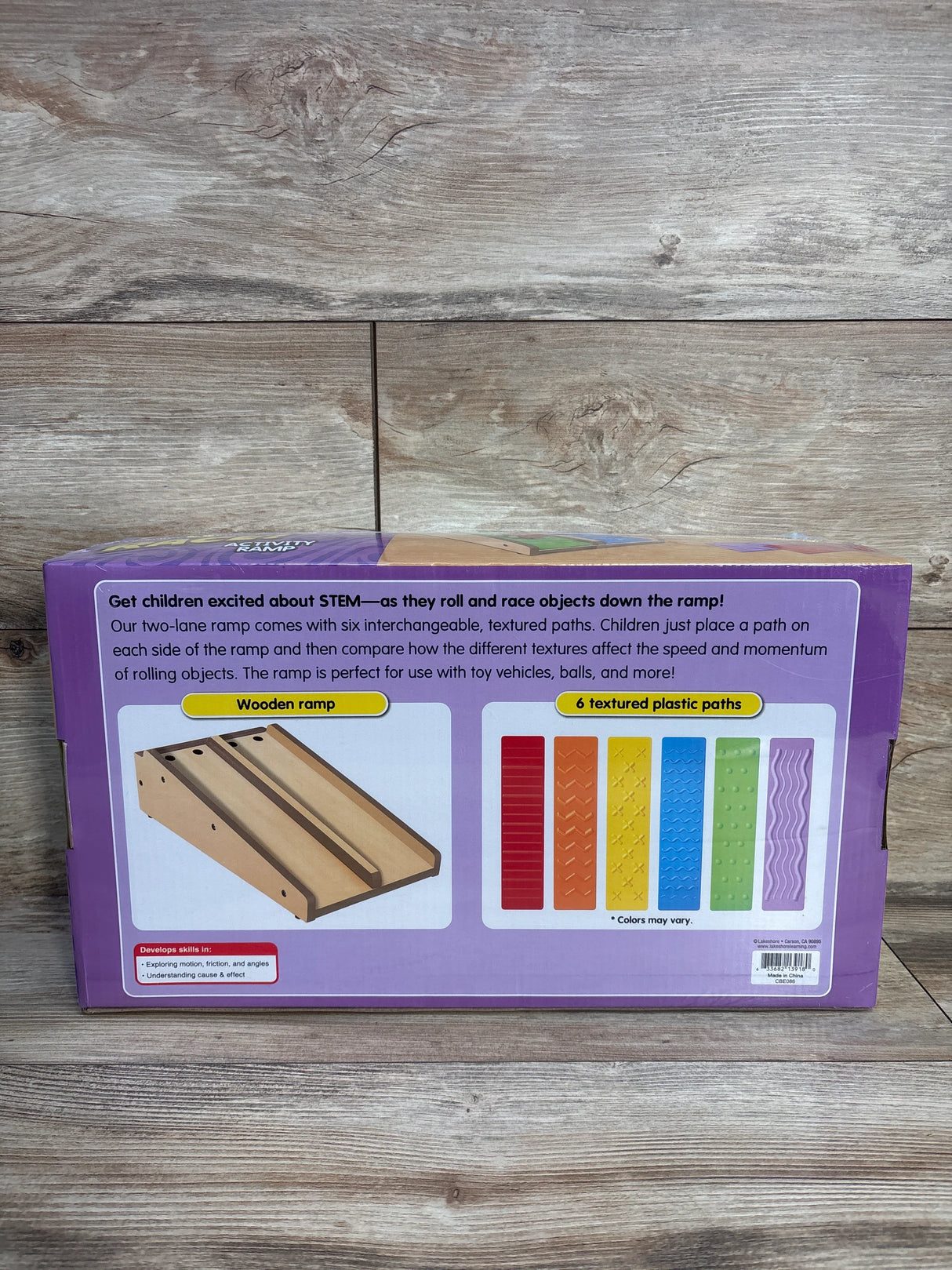 STEM ramp toy box showing wooden ramp and six colorful textured plastic paths for kids.