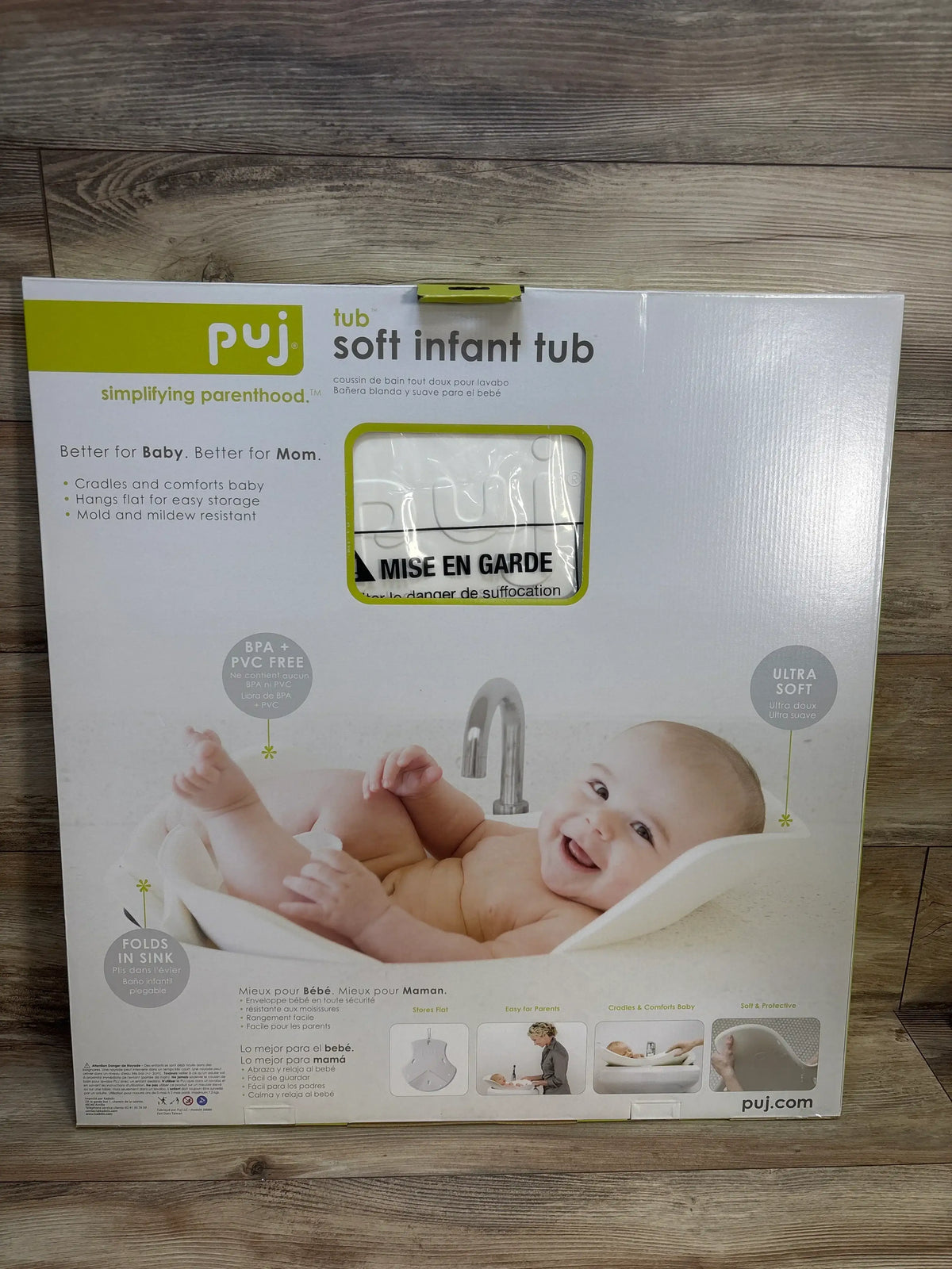 Puj soft infant tub packaging featuring smiling baby in white baby bathtub, BPA-free, folds for sink use.