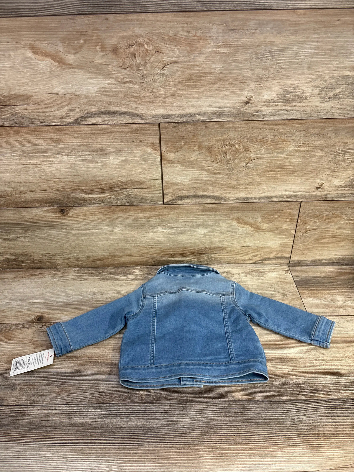 New Cat & Jack blue denim knit-like jacket for infants size 6-9m on a wood background