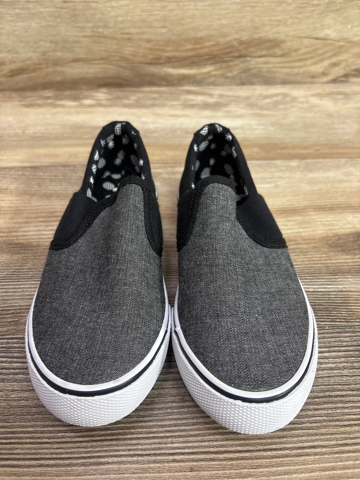 Cat & Jack grey canvas slip-on sneakers for kids, size 13c, on a wooden surface