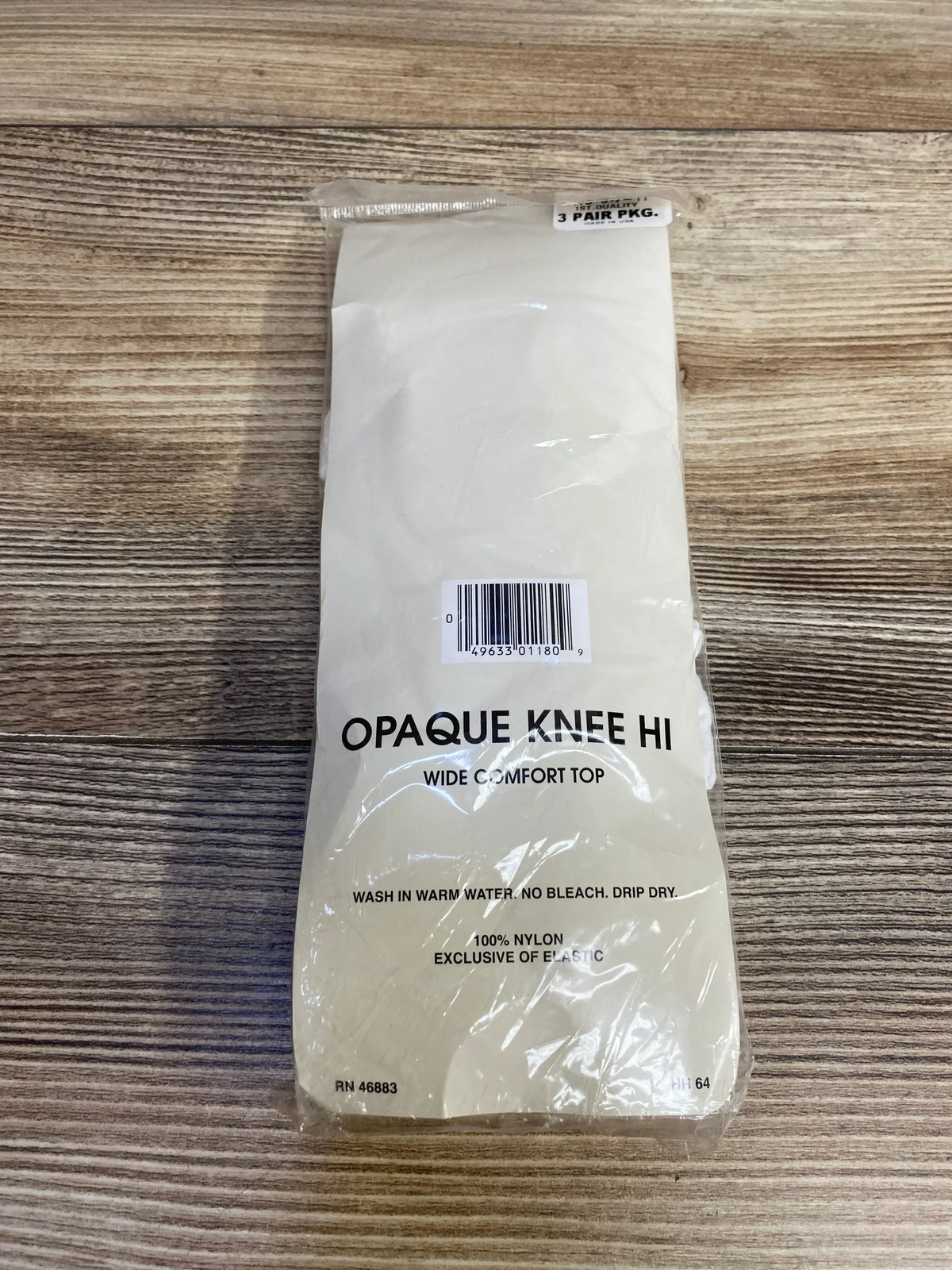 Opaque knee high stockings 3 pair package with wide comfort top on wood surface