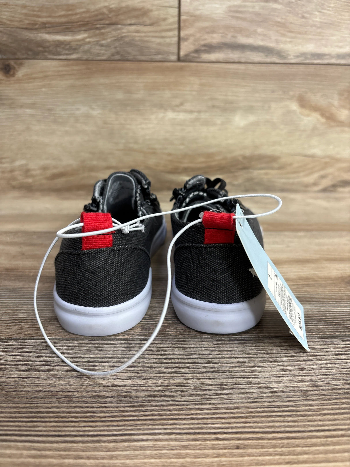 Back view of Cat & Jack Lucian double-zipper toddler sneakers in grey showing red heel tabs and white soles on wooden floor