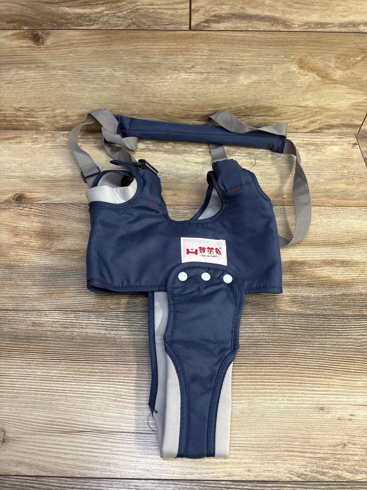 Blue Me n Mommy To Be Han Han Rabbit baby walking harness on a wooden floor.