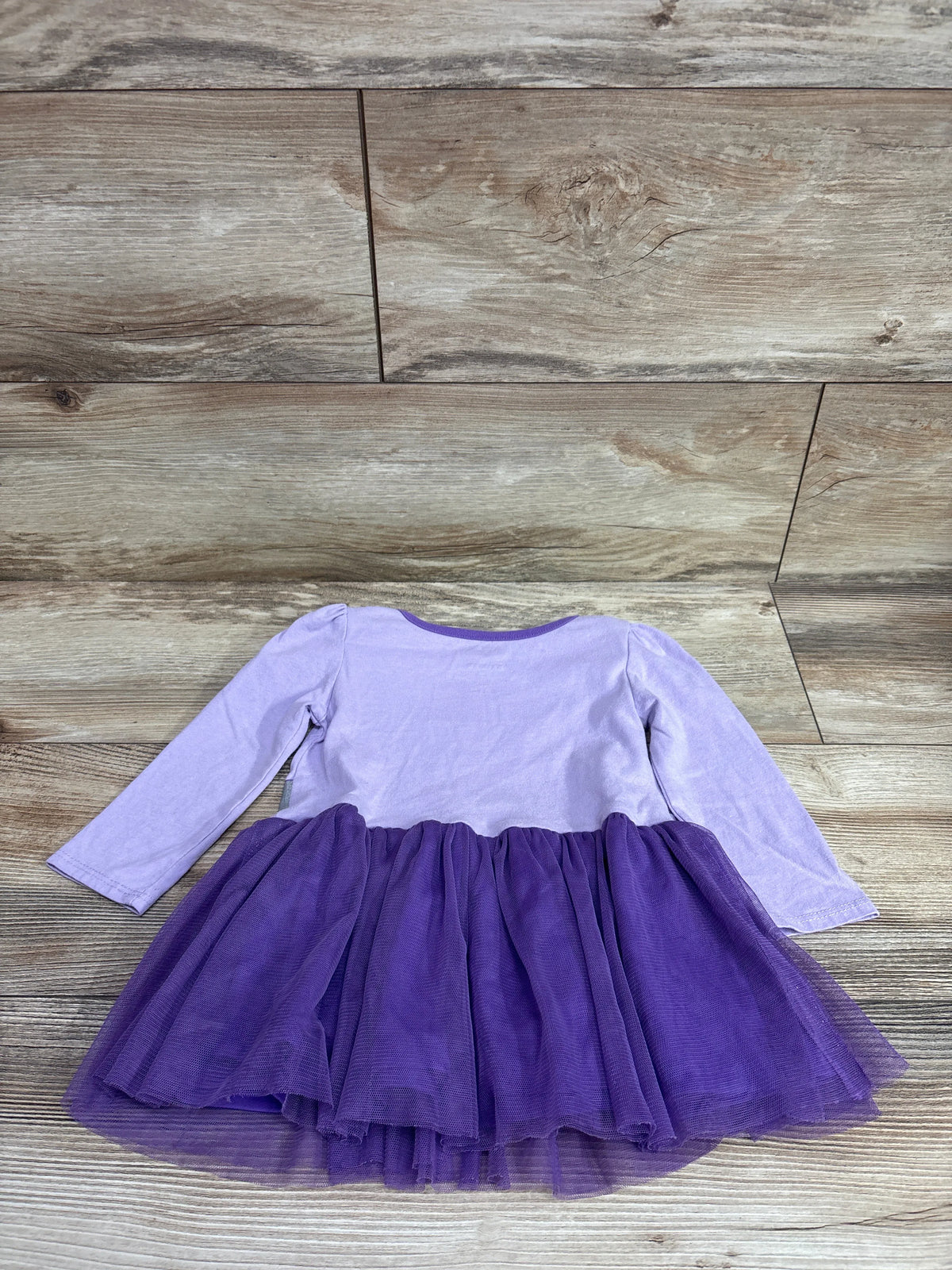 DC Batman purple long sleeve tulle dress for toddlers on a wood background