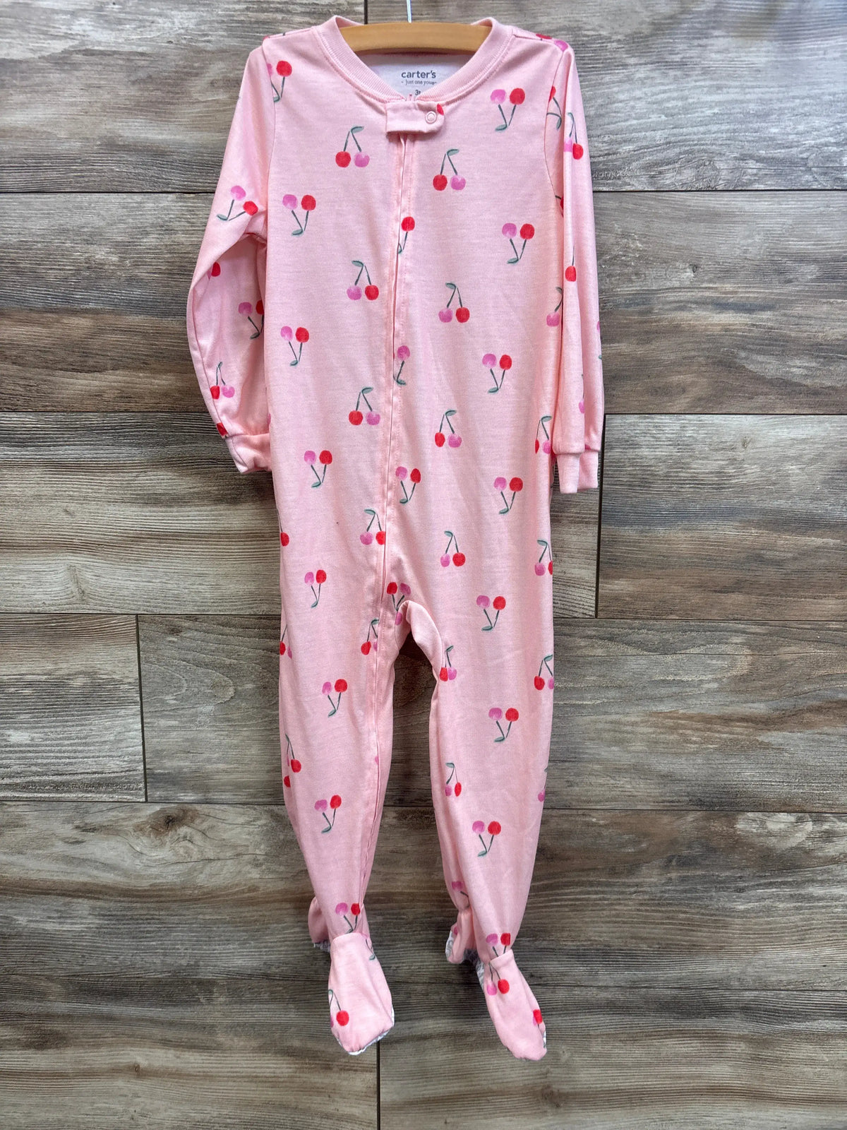 Pink Me n Mommy To Be cherry print baby sleeper with footies on a wooden background