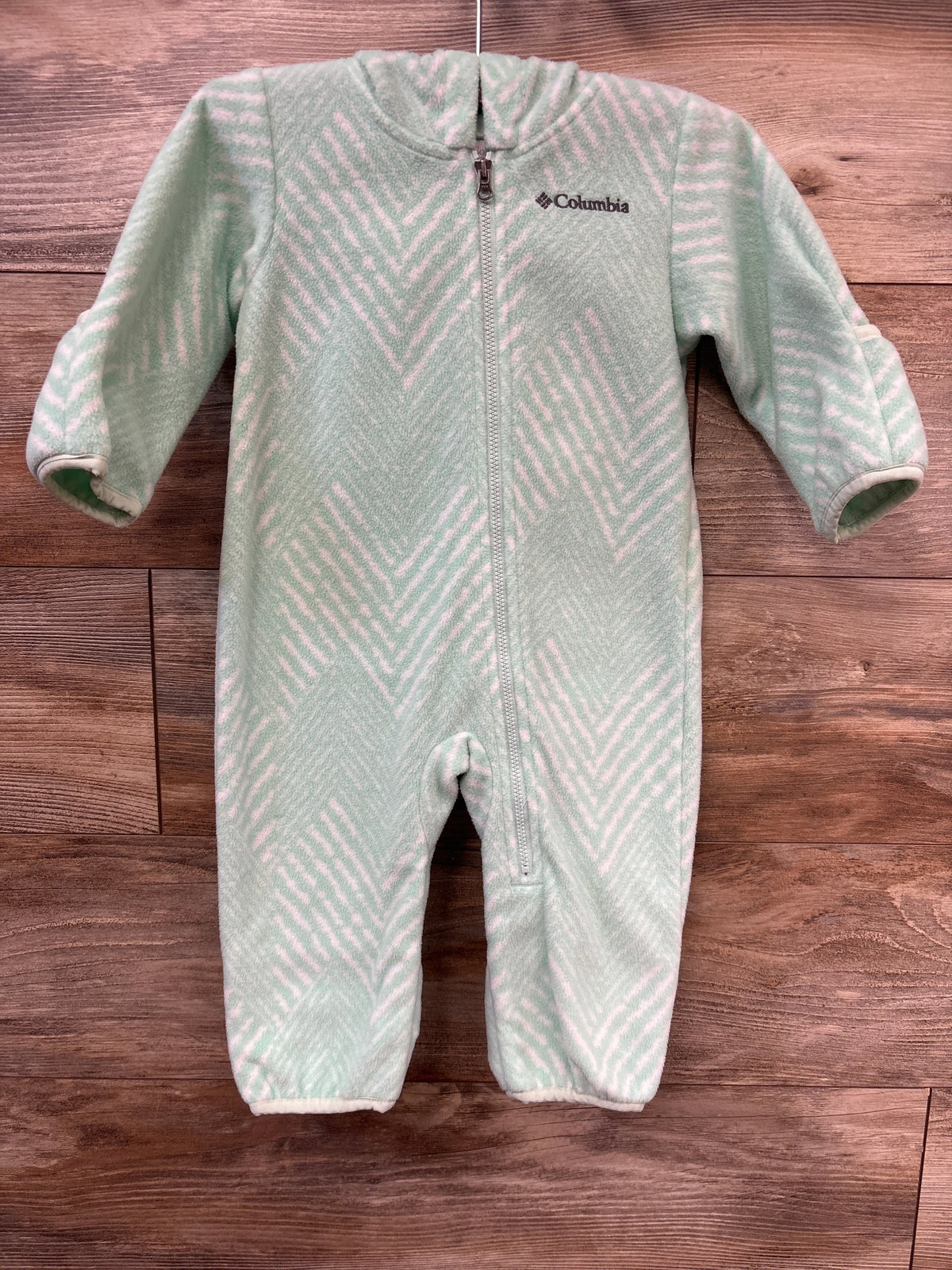Front view of Columbia Snowtop II fleece bunting in teal, size 6-12 months, with full zipper and pink pattern on wood background
