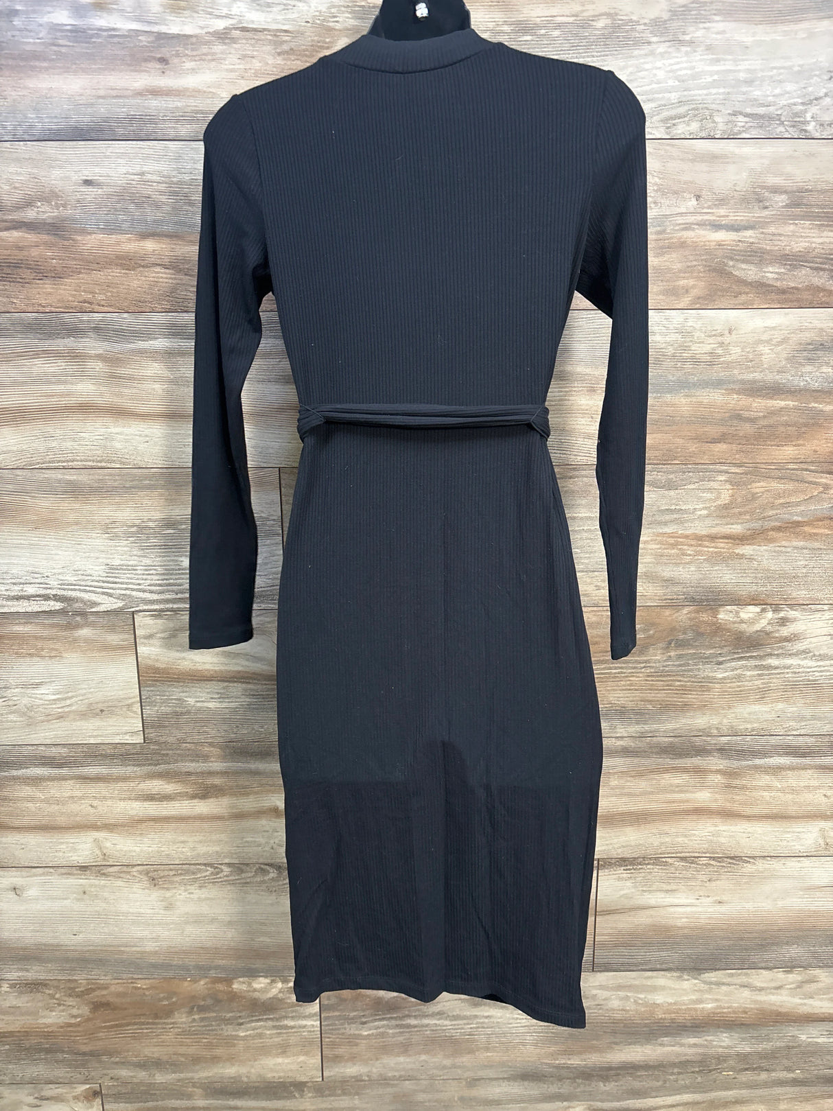 Black ribbed long sleeve midi dress on mannequin against wood backdrop