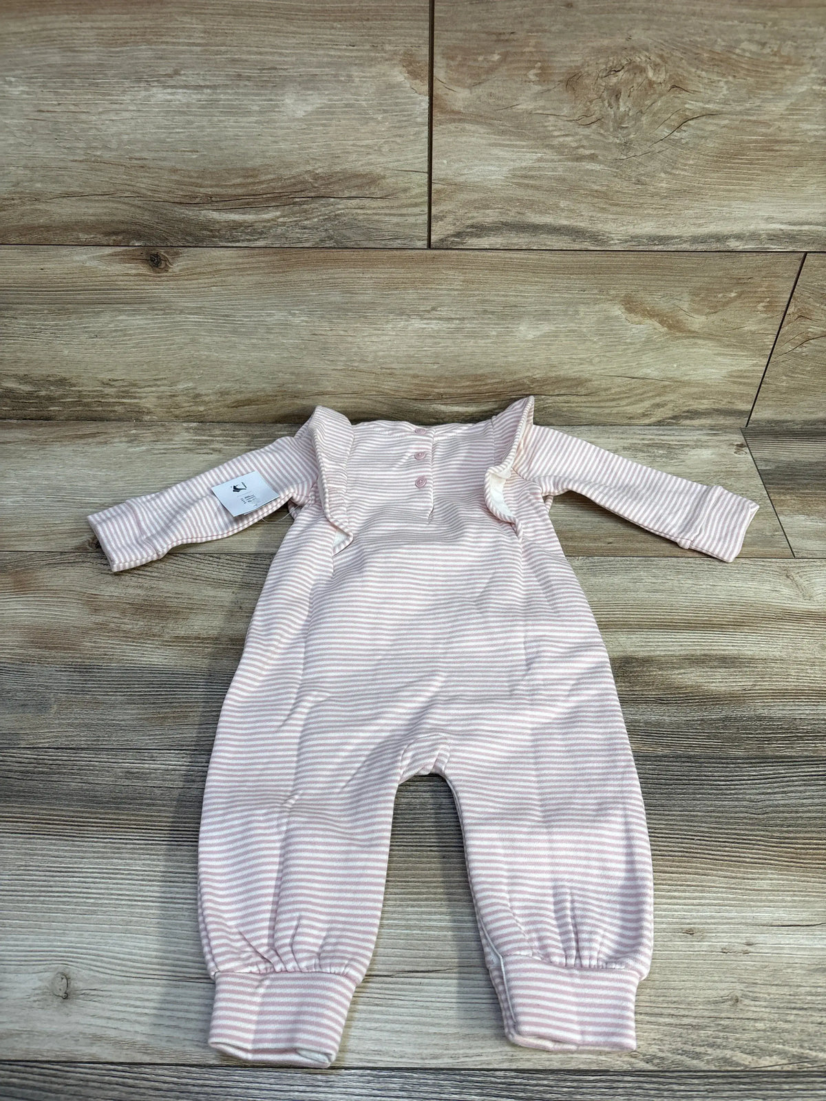 Front view of Baby Gap Paddington VintageSoft footless coverall showcasing pink and white stripes and ruffle details on wood