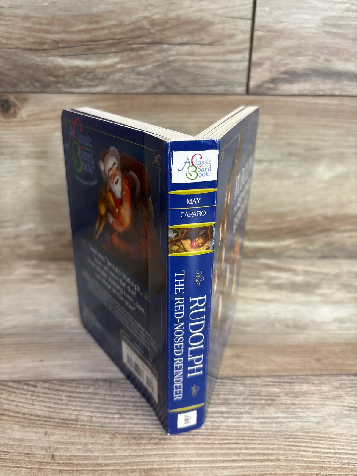 Rudolph the Red-Nosed Reindeer classic board book for kids, featuring Santa and festive holiday art