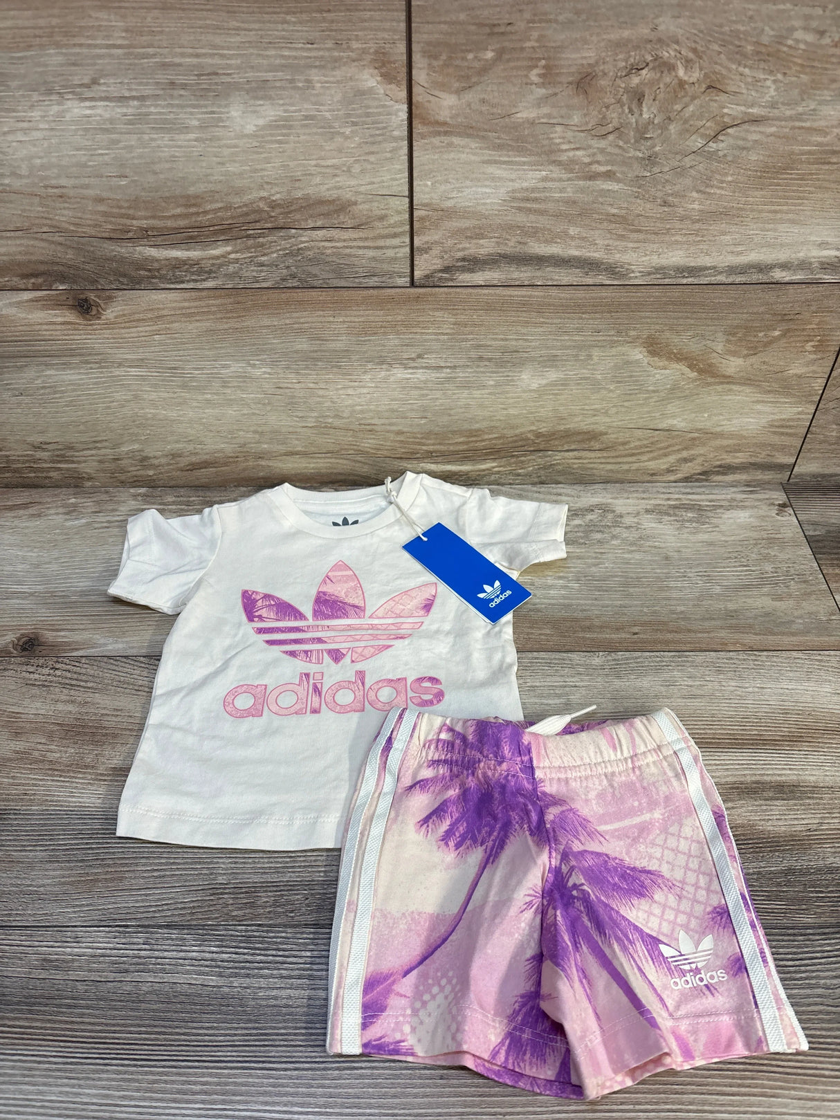Kids Adidas pink logo t-shirt and palm print shorts set for toddlers on wood floor