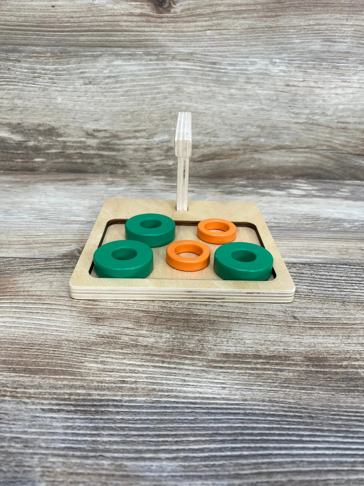 Angled view of Monti Kids Curved Dowel showcasing smooth curved beech wood with natural finish on white background