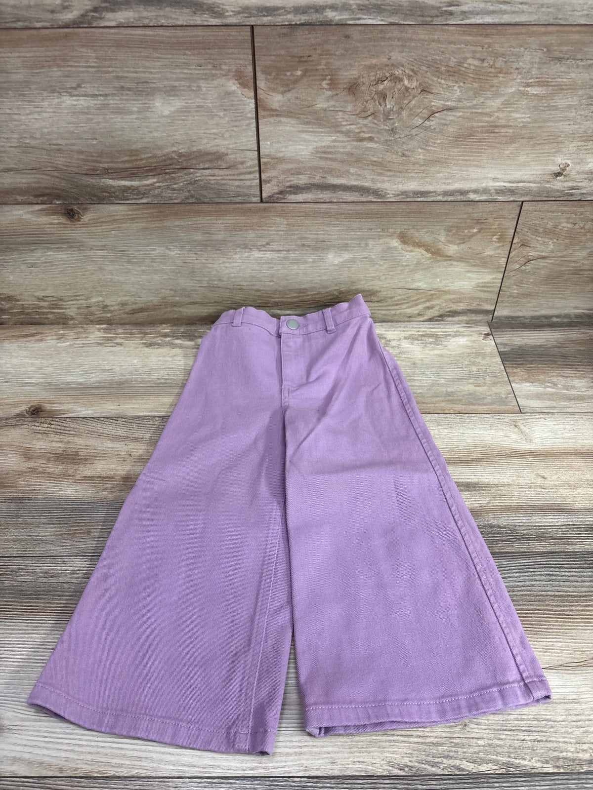 Lavender wide-leg pants for toddlers by Me n Mommy To Be on a wooden background.