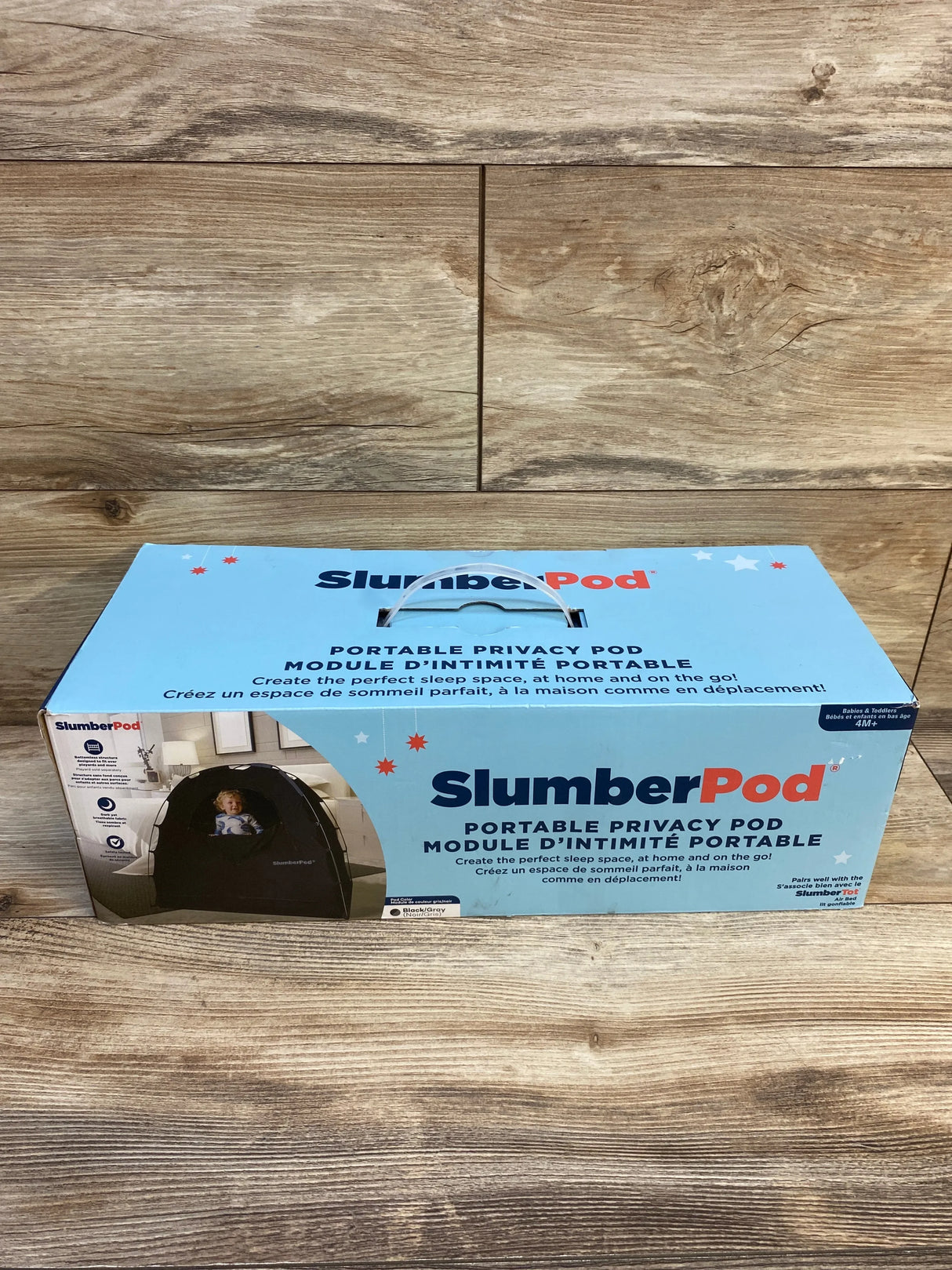 SlumberPod portable privacy pod box for babies and toddlers on wooden floor