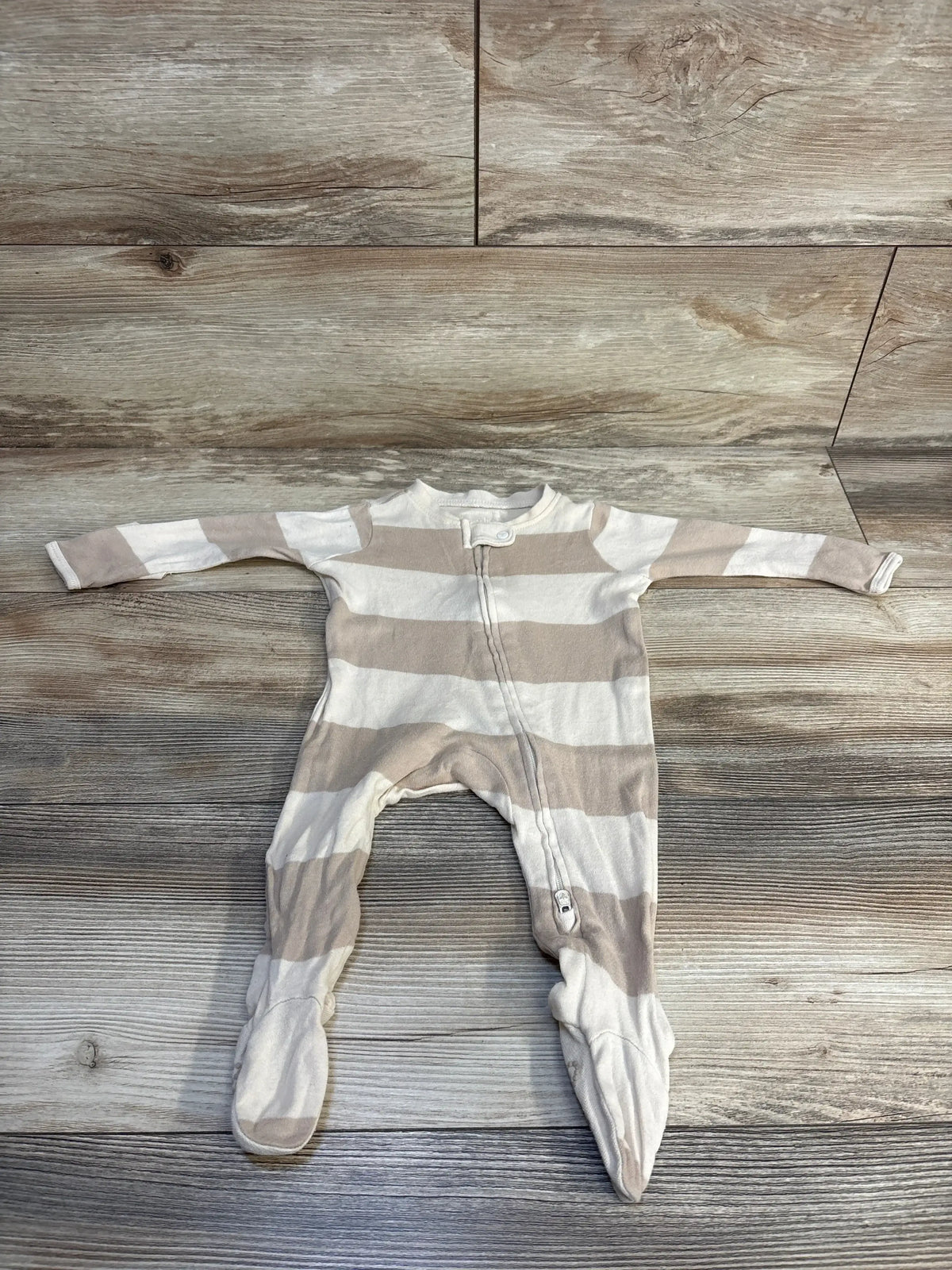 Striped baby footed onesie on wooden floor, soft cotton, cozy sleepwear for infants