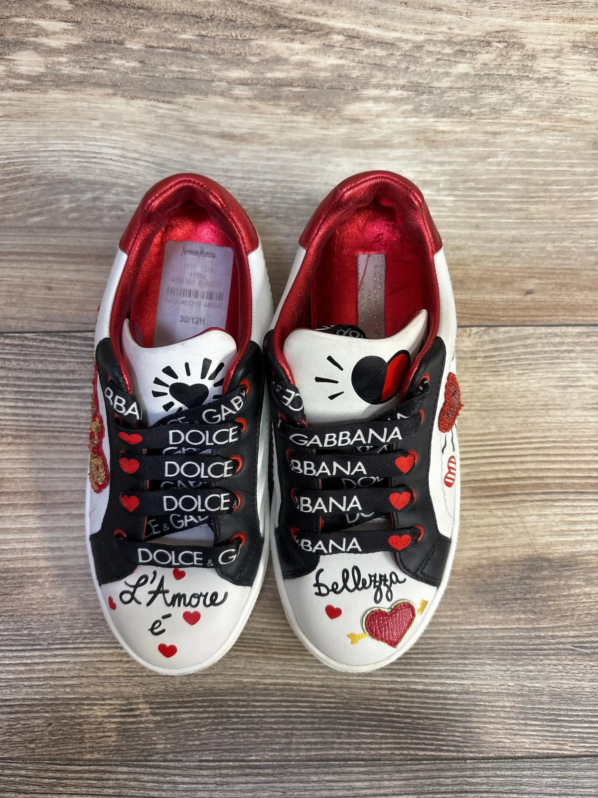 Top view of Portofino DG Amore sneakers showcasing black branded laces and red heart details on wood