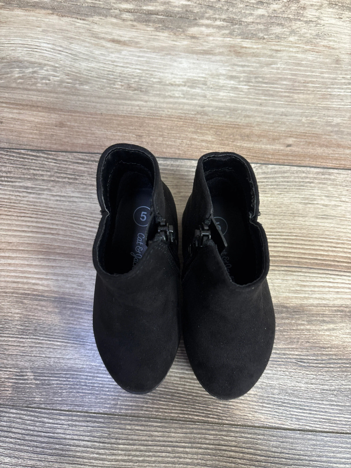 Pair of black toddler ankle boots size 5 on wood floor