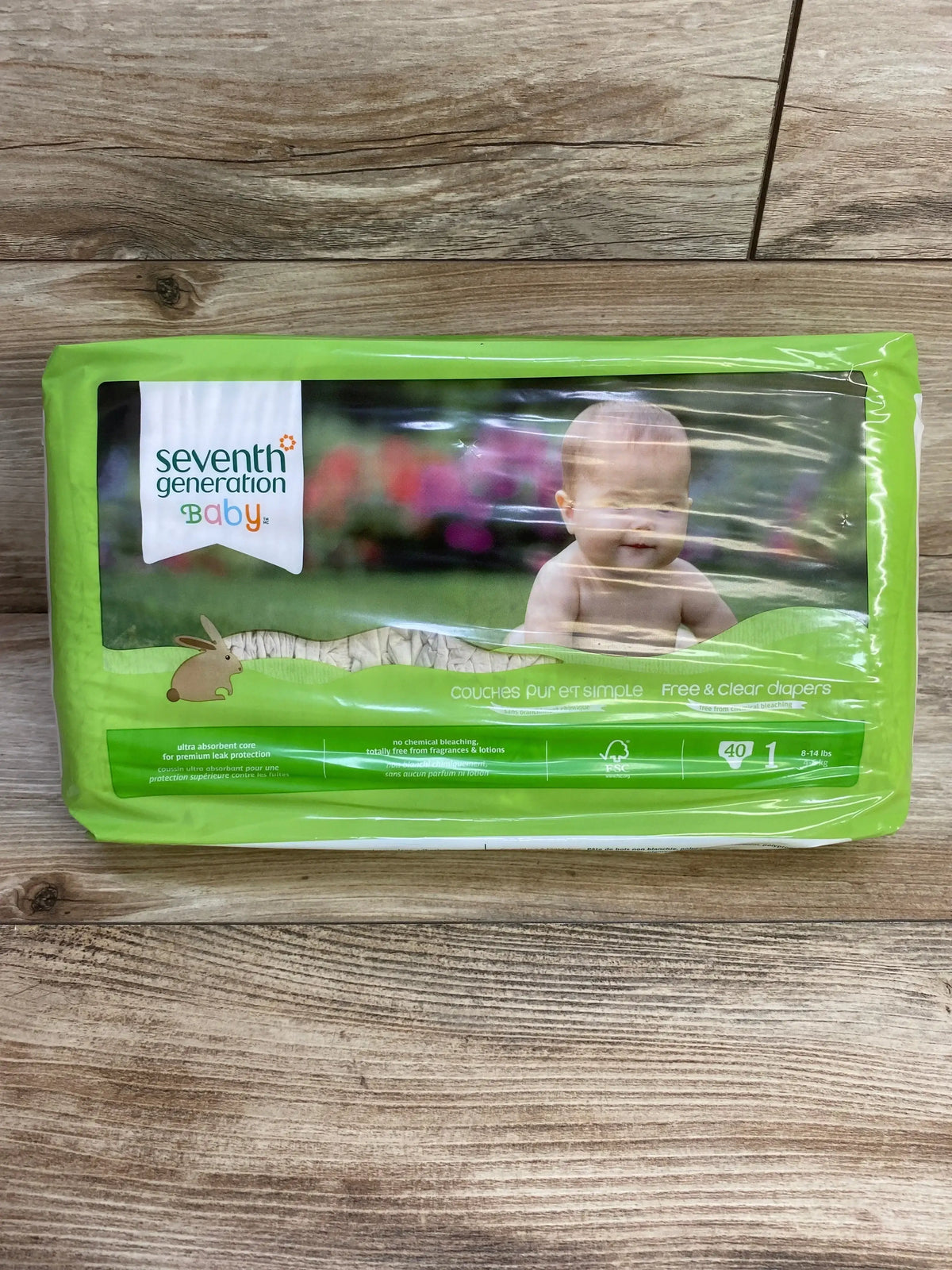 Front view of Seventh Generation Free and Clear diaper pack, size 1, 40 count, showing baby photo and logo on wood background