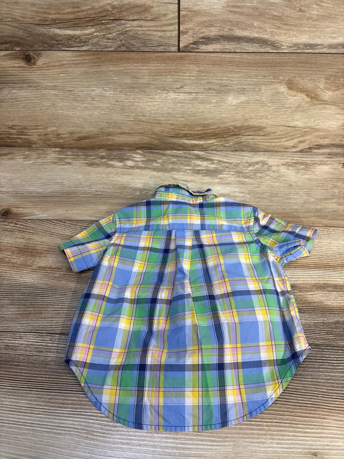 Back view of Ralph Lauren short-sleeve plaid button-down shirt size 9M showing blue, green and yellow plaid on wooden floor